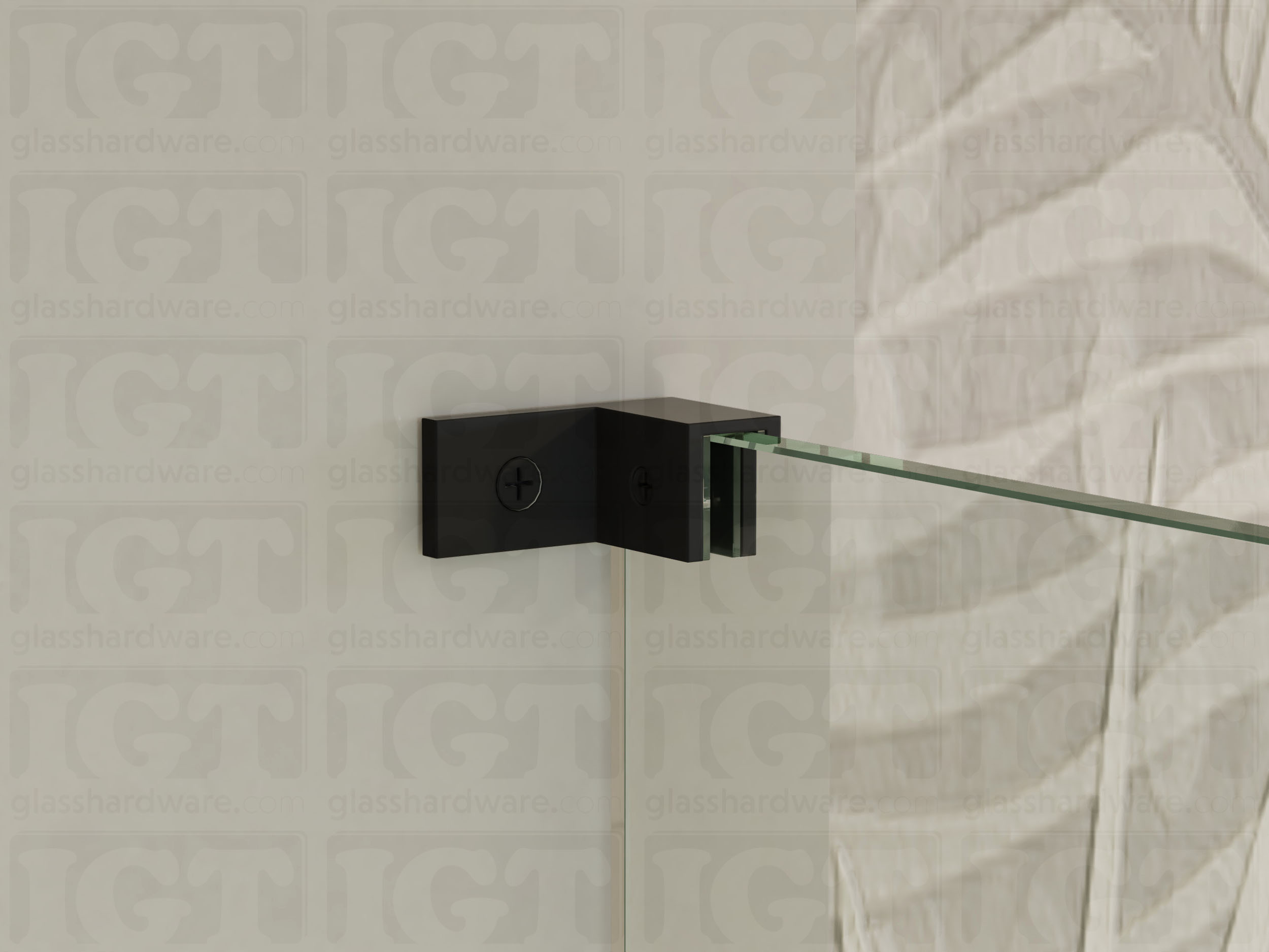 A close up of the Right Wall-to-Glass Sleeve Over Clamp installed on a frameless glass shower enclosure. The clamp is securely mounted to the shower's wall, providing additional support to the overall installation. Matte Black.