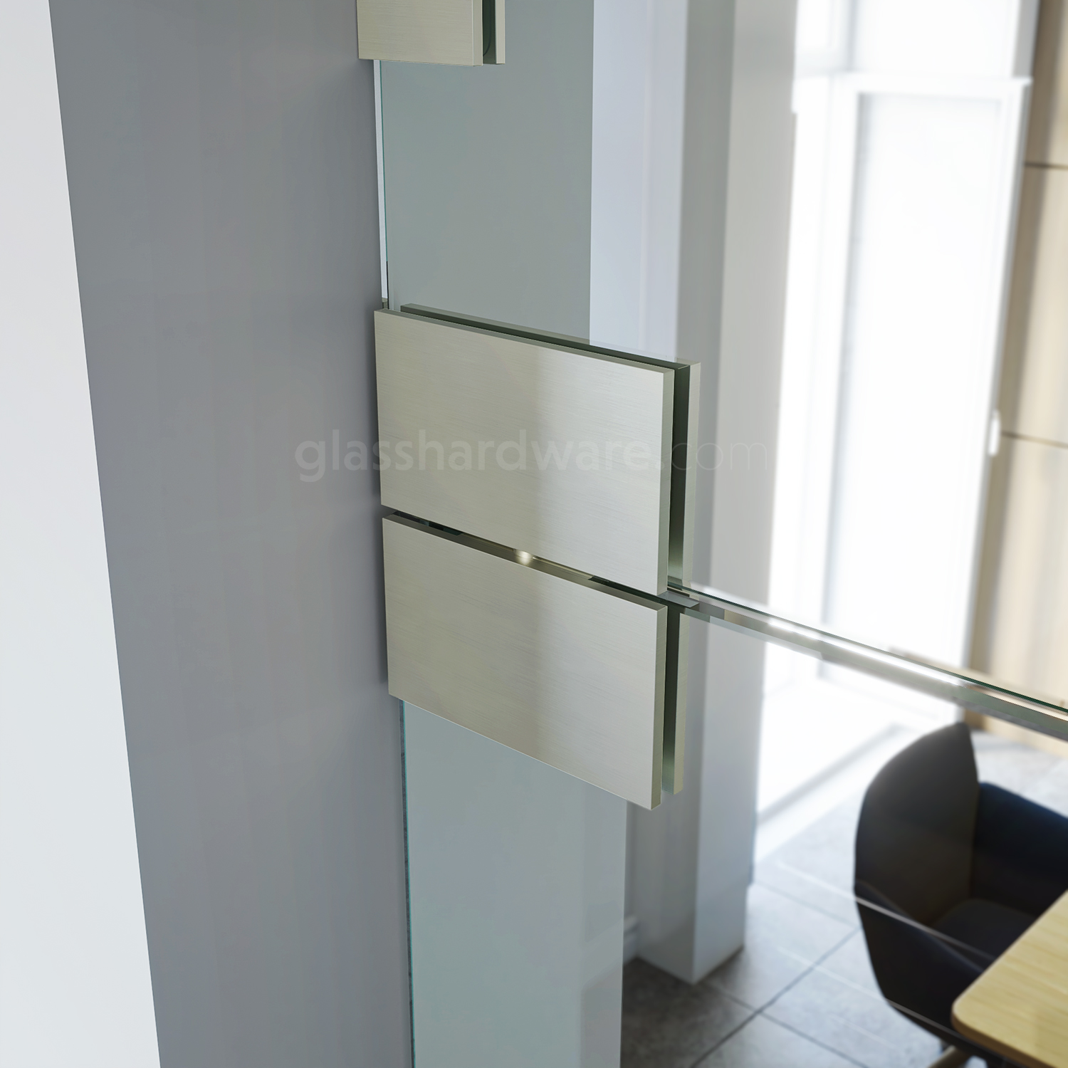 Close up of the Heavy Duty Glass-to-Glass 180 Degree Pivot Hinge installed between a glass door and transom. The hinge features sleek square edges, adding to the sense of refinement found in the conference room.