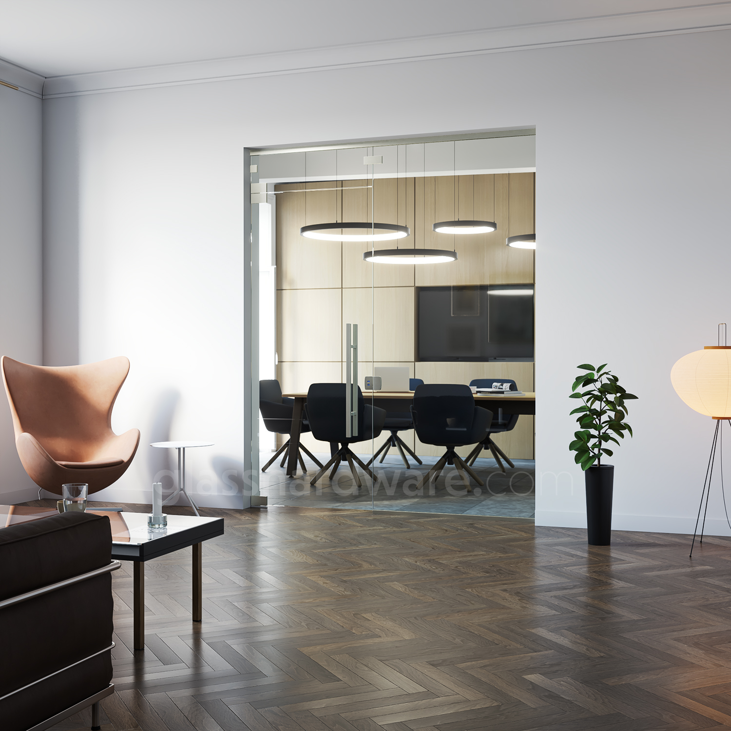 A modern interior view with a glass door seperating a cozy lounge area from a sleek conference room. The glass door is mounted with two pivot hinges, including the Heavy Duty Top and Bottom Malibu Pivot Hinge. Soft, natural lightning reflects off of the hinge's brass construction, while contrasting with the lounge's warm wood herringbone floor.