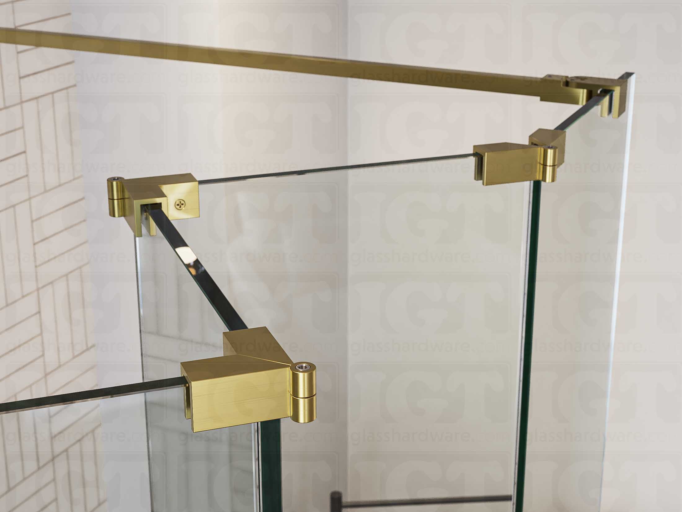 A close up of three Glass-to-Glass Adjustable Sleeve Over Clamps in Gold Brushed installed on a doorless glass shower enclosure alongside a matching support bar.