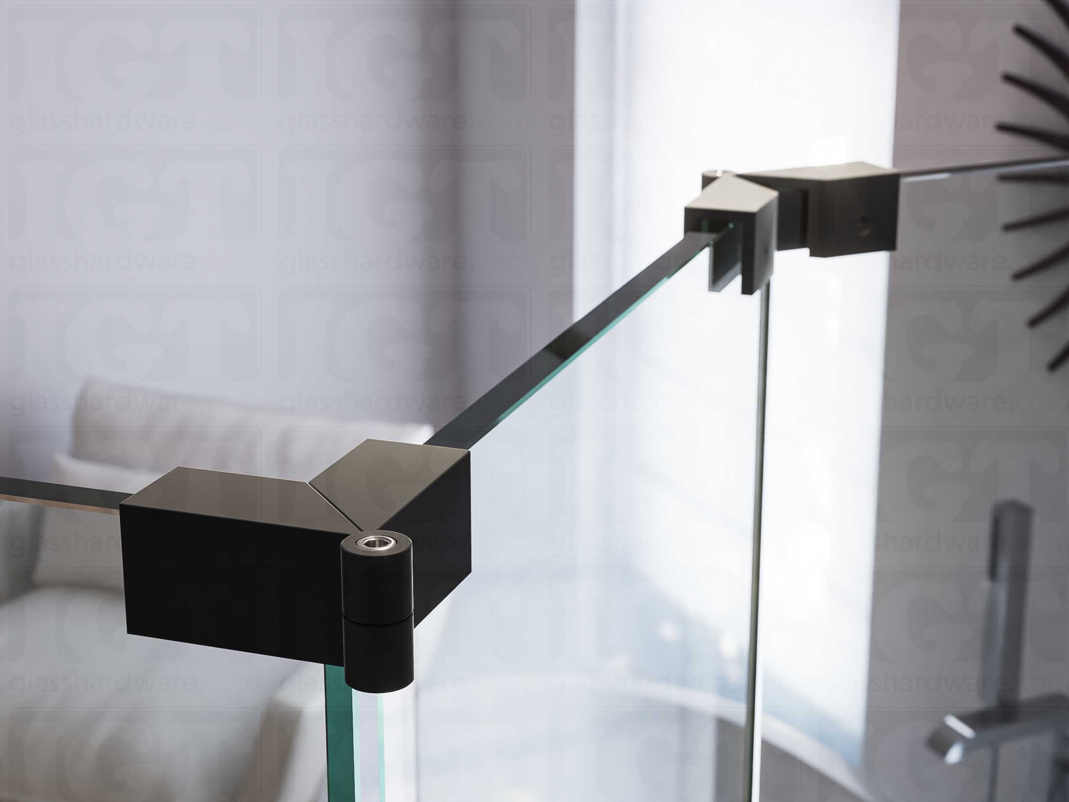 A close up of two Glass-to-Glass Adjustable Sleeve Over Clamps installed on a doorless glass shower enclosure. Matte Black.