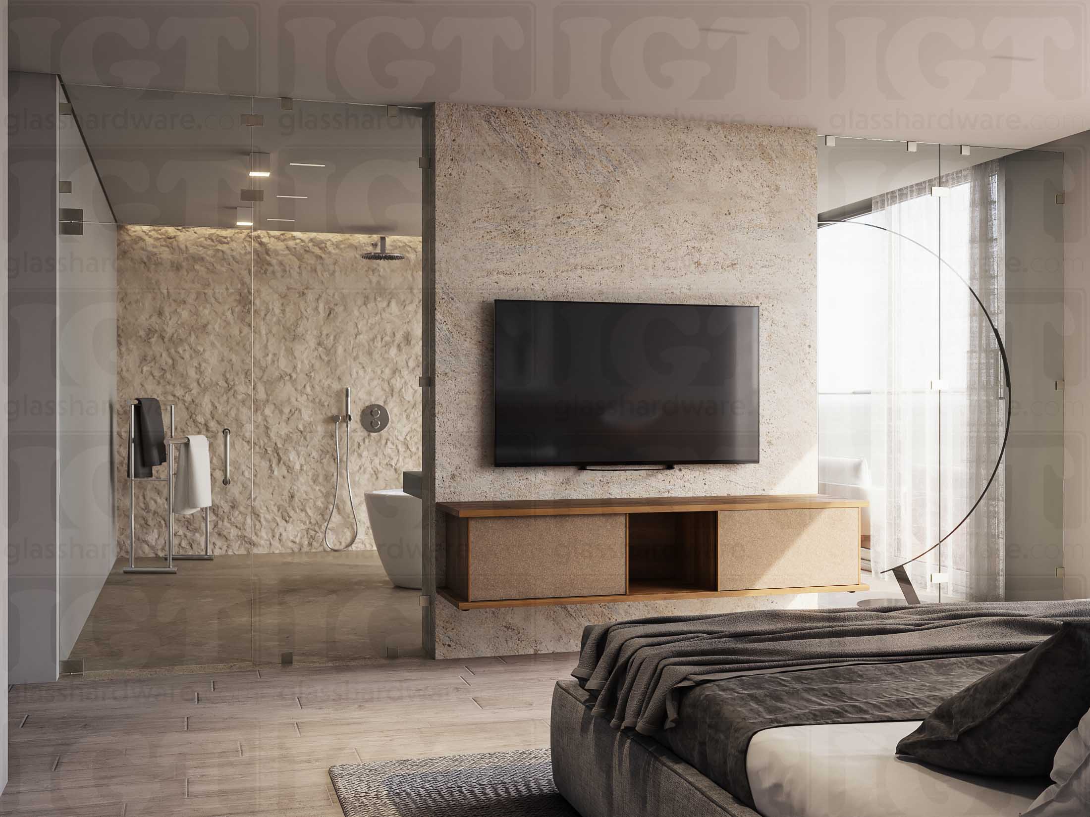 A luxurious bedroom with an en-suite bathroom separated by a glass partition, installed with various glass clamps, including the Square 180 Degree Glass-to-Glass Clamp (Full Plates). The bathroom features a textured stone wall that adds warmth and a natural element to the otherwise sleek and contemporary bedroom design. Brushed Nickel.