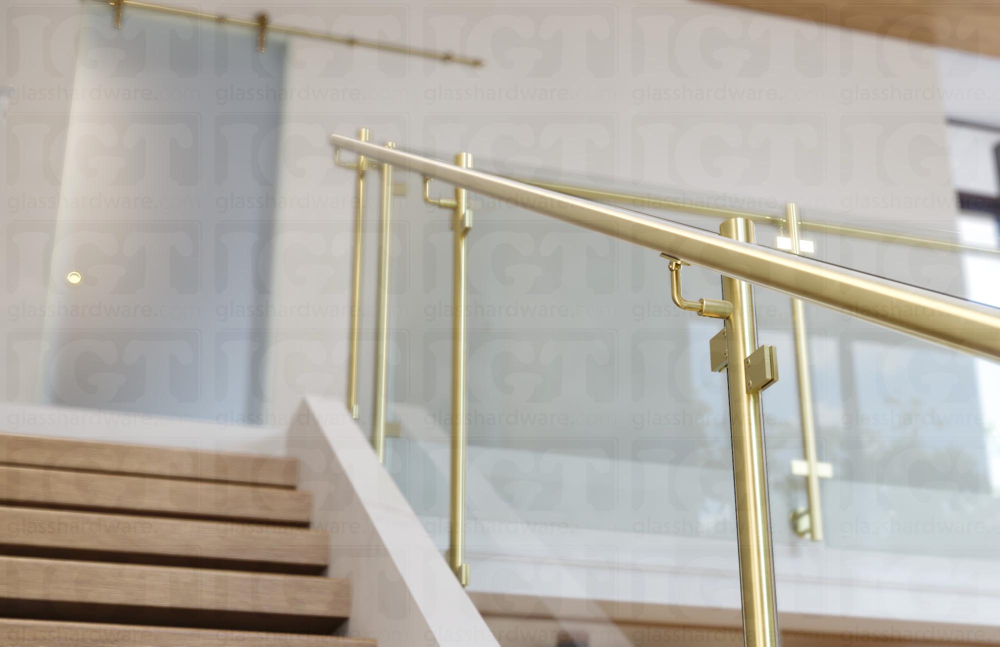 A stairway glass railing system using the 120" Round Handrail, Gold Brushed.