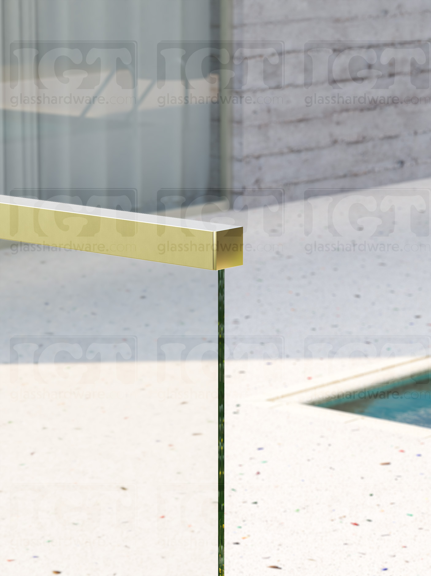 A close-up of one end of the 120" Square Cap Rail in Gold Brushed finish, installed on a poolside glass railing system.