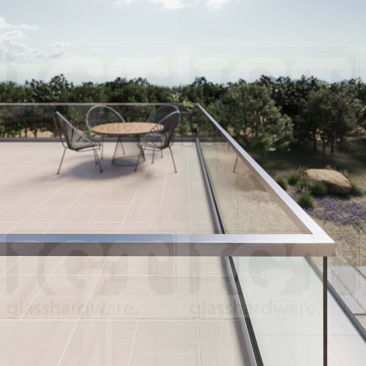 A close-up of a corner joint on a glass railing system, featuring the 220" Square Cap Rail in Brushed Stainless.