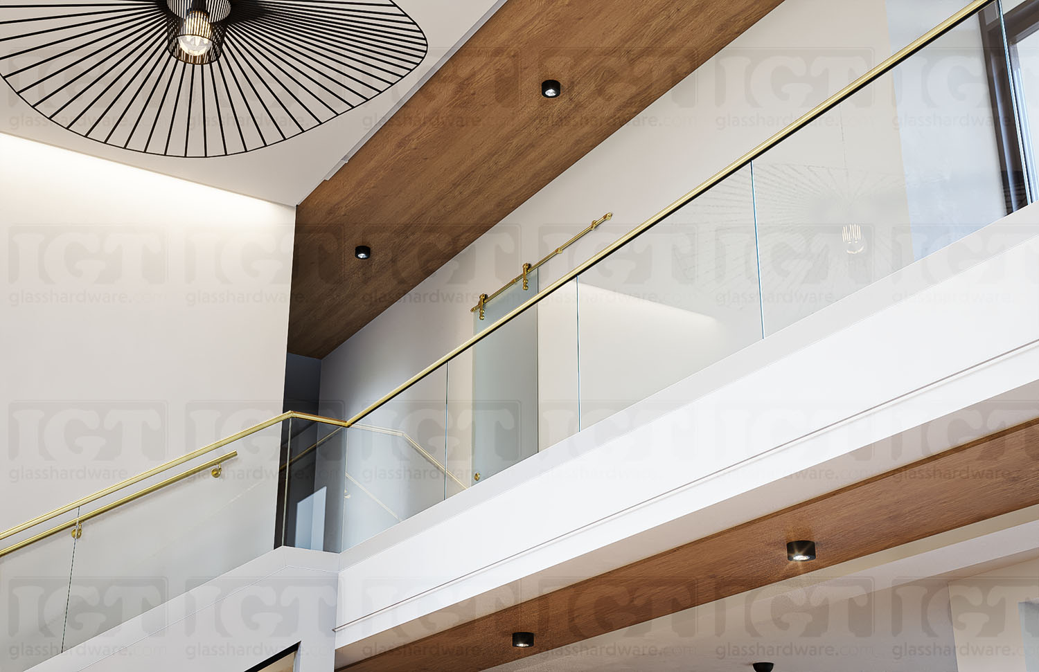 A two-story stairway glass railing system using the 120" Round Cap Rail, Gold Brushed.