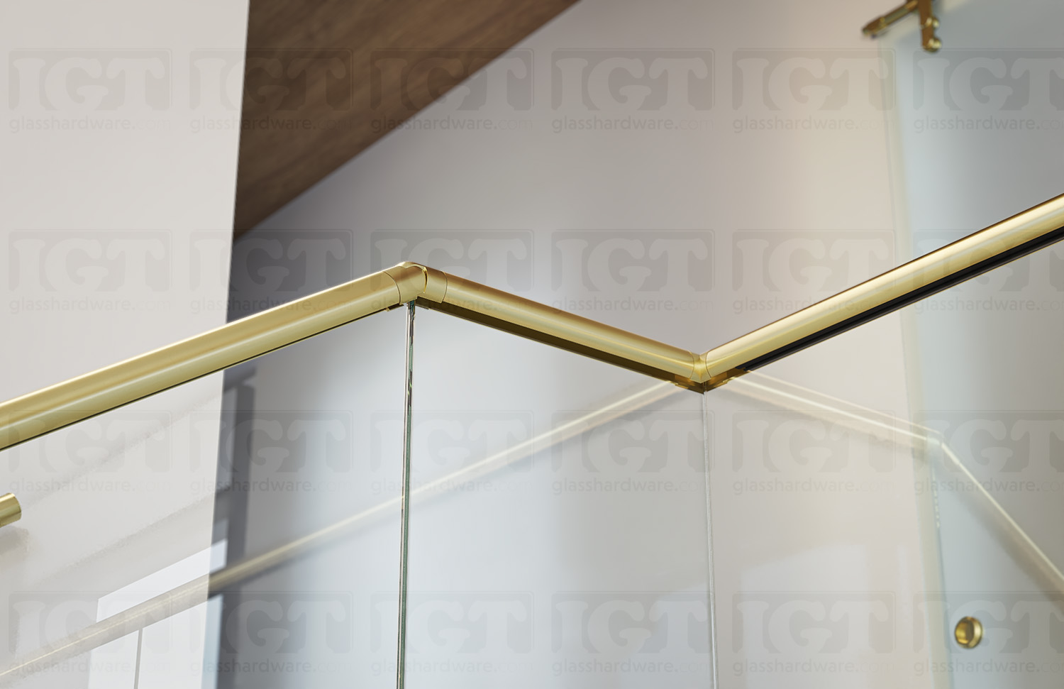 A close-up of a joint in a stairway glass railing system using the 120" Round Cap Rail, Gold Brushed.