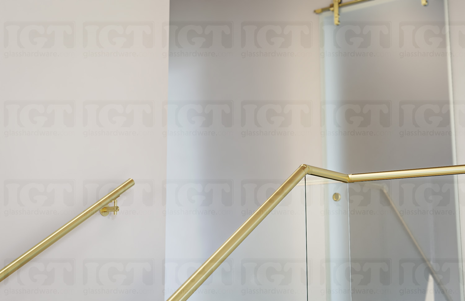 A view from the second floor of the stairway glass railing system, using the 120" Round Cap Rail, Gold Brushed.