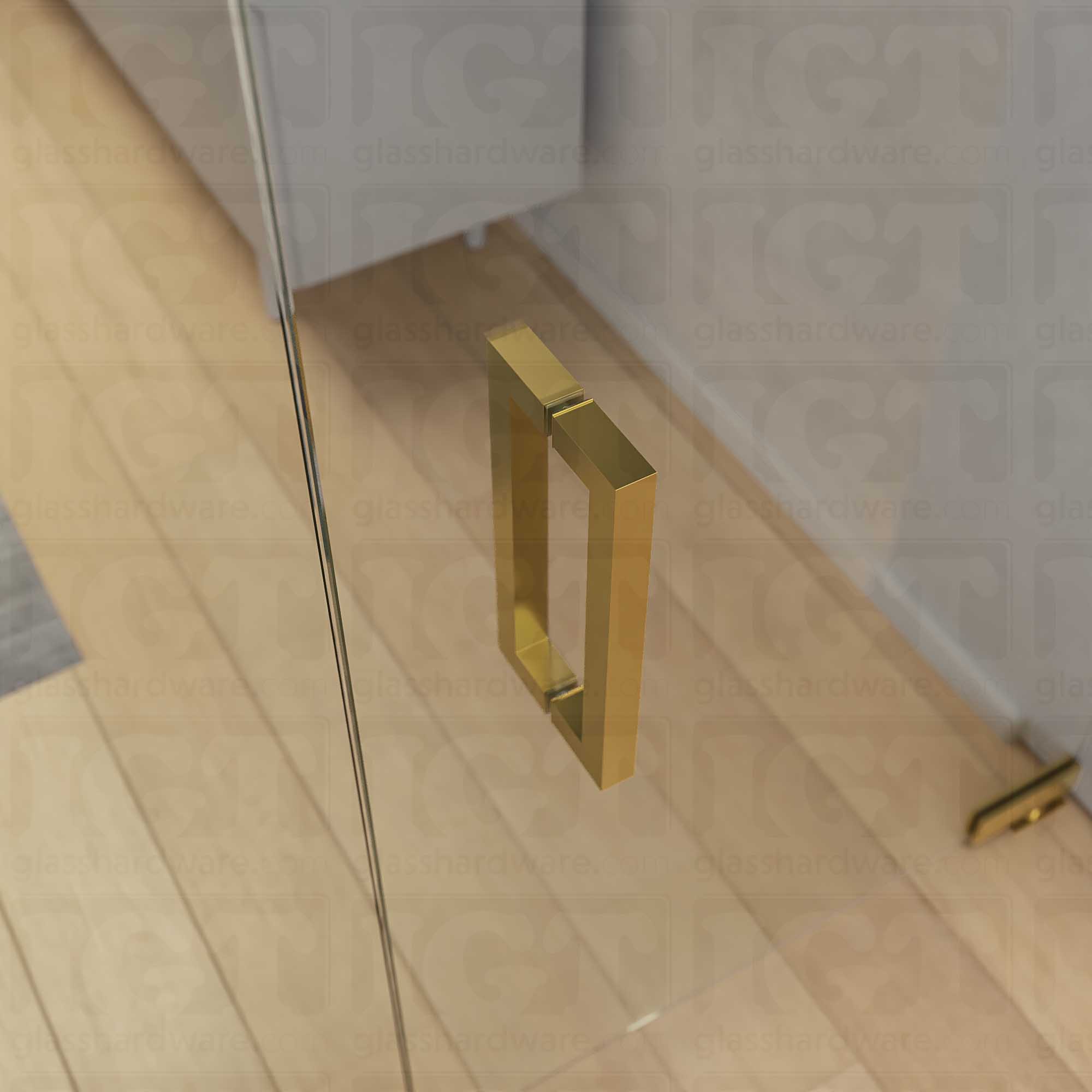 A close-up from above of the 12-inch Back-to-Back Square Pull Handle in Gold Brushed, installed on a commercial glass door.