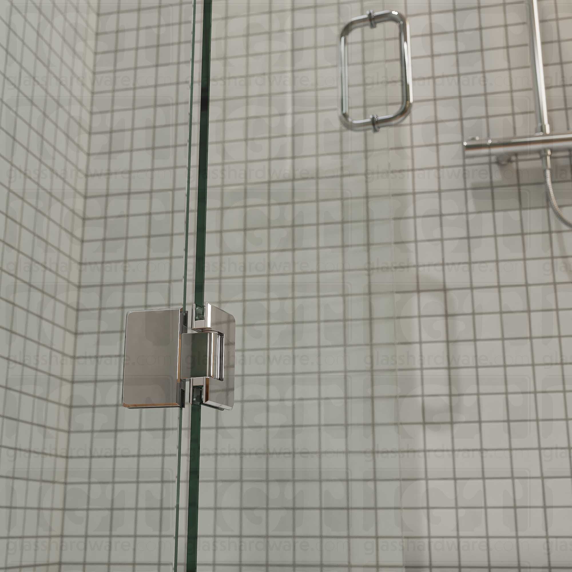 A close-up view of the bottom Glass-to-Glass 180 Degree Bilboa Hinge installed on a modern shower door in the open position. Chrome Polished.