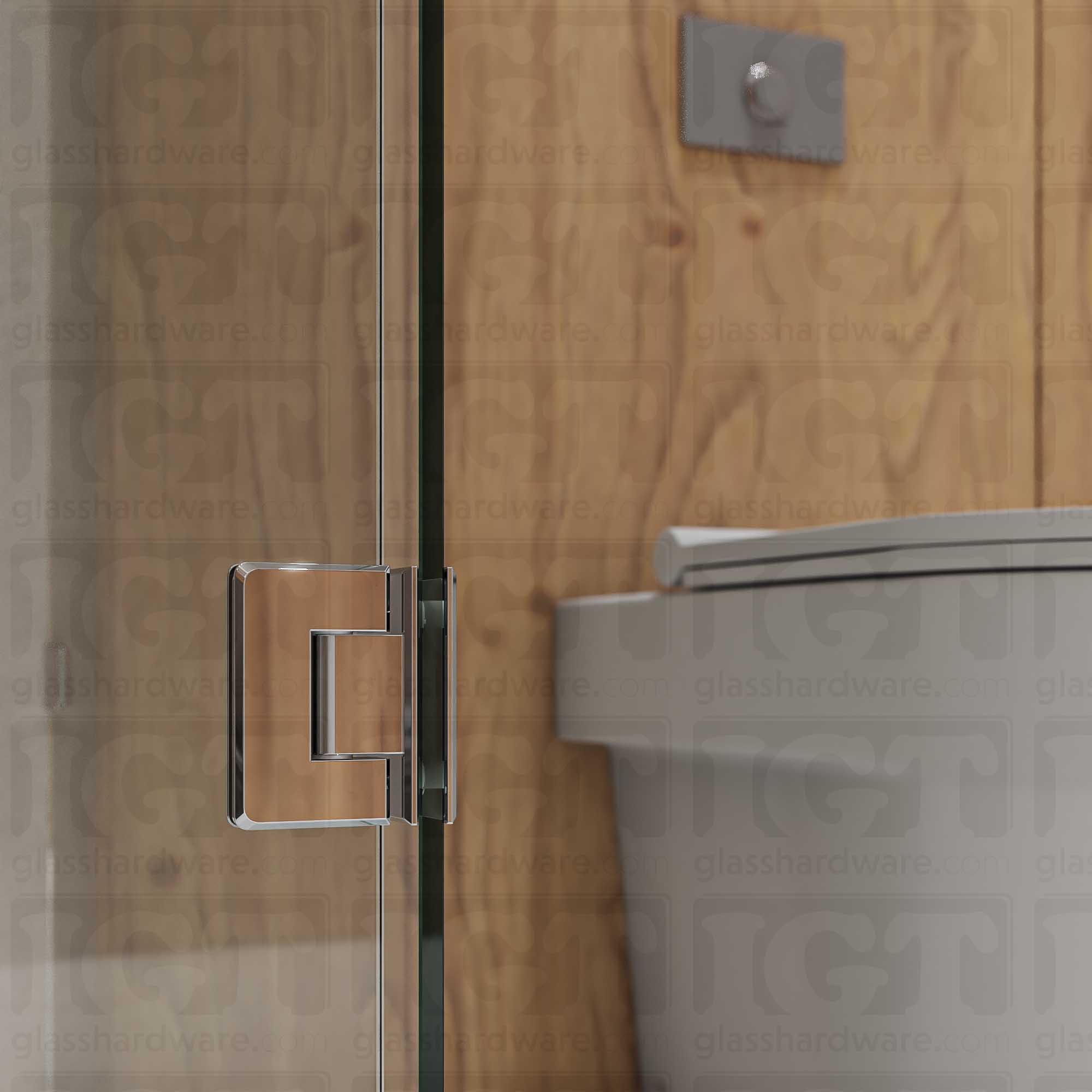 A close-up view of the bottom Glass-to-Glass 90 Degree Bilboa Hinge installed on a modern shower door, showcasing its beveled-edge design in more detail. Chrome Polished.