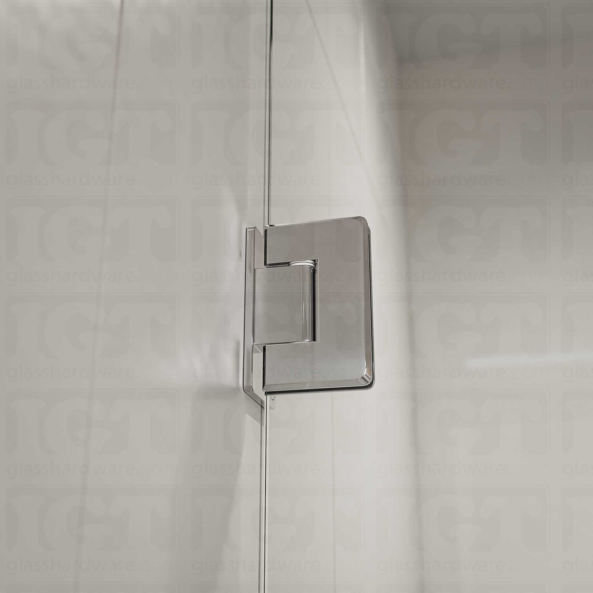 A close-up view of the Wall-to-Glass Offset Back Bilboa Hinge installed on a modern shower door, showcasing it's rounded corners and beveled edges. Chrome Polished.