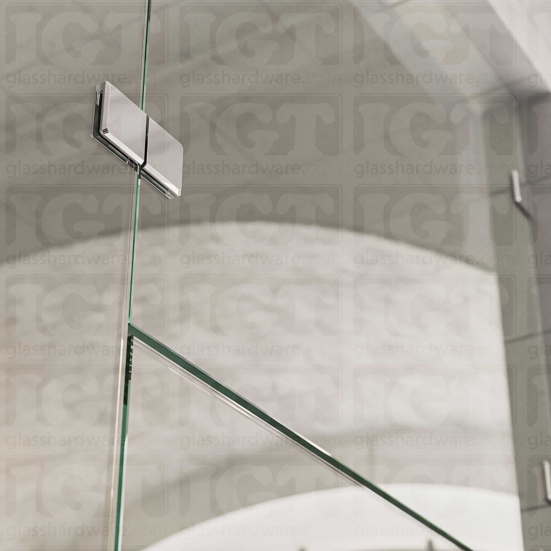 A close-up view of the Glass-to-Glass 180 Degree Bilboa Clamp (Split Face), installed on a frameless glass shower enclosure. The clamp's Solid Brass construction provides a secure and durable connection for the shower's panels. Chrome Polished.