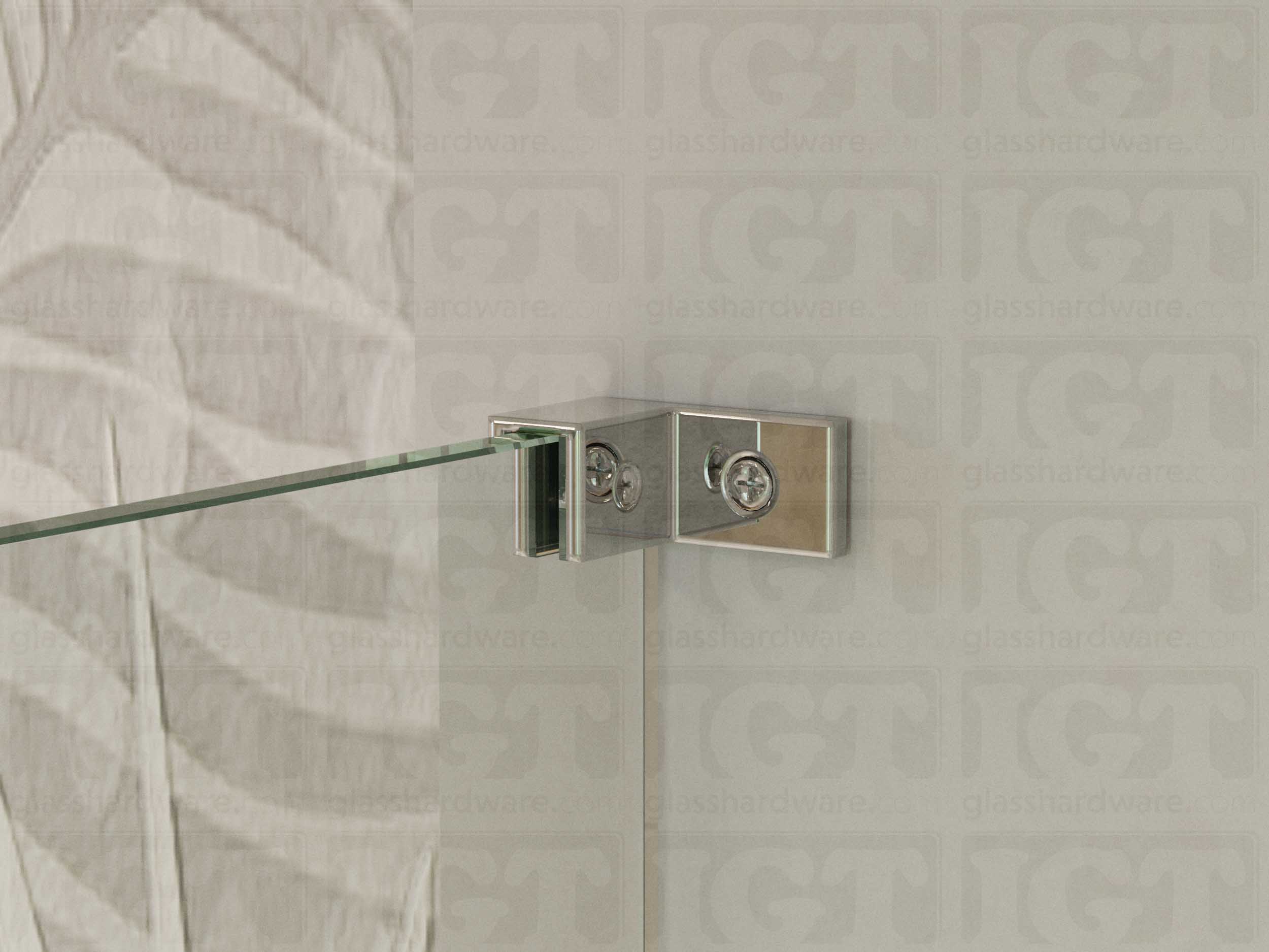 A close up of the Left Wall-to-Glass Sleeve Over Clamp installed on a frameless glass shower enclosure. The clamp is securely mounted to the shower's wall, providing additional support to the overall installation. Chrome Polished.