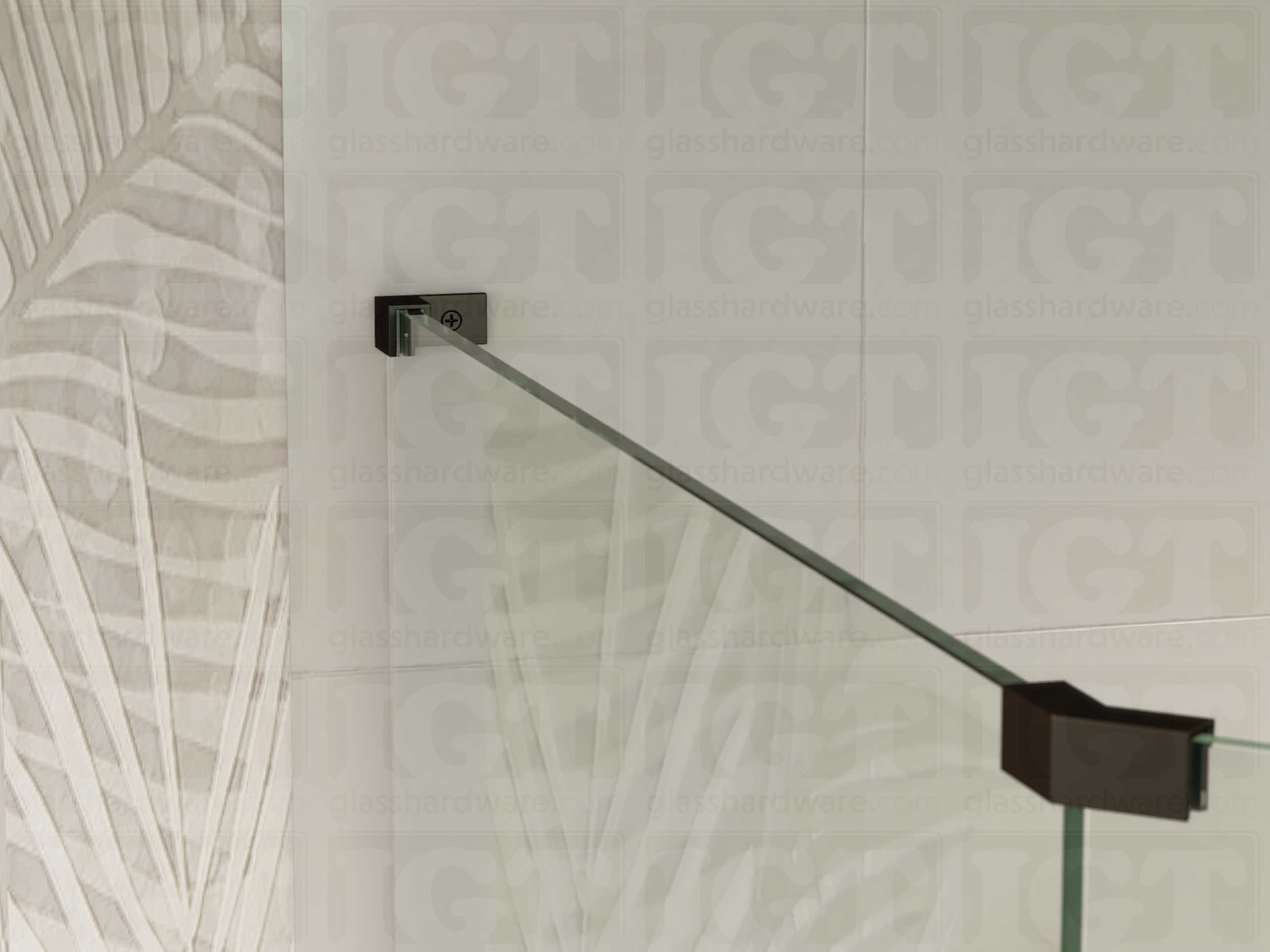 A view of the glass shower enclosure's upper section. The fixed panel is secured to the wall with a Left Wall-to-Glass Sleeve Over Clamp, and joined to an adjacent panel with a glass-to-glass clamp. Oil Rubbed Bronze.