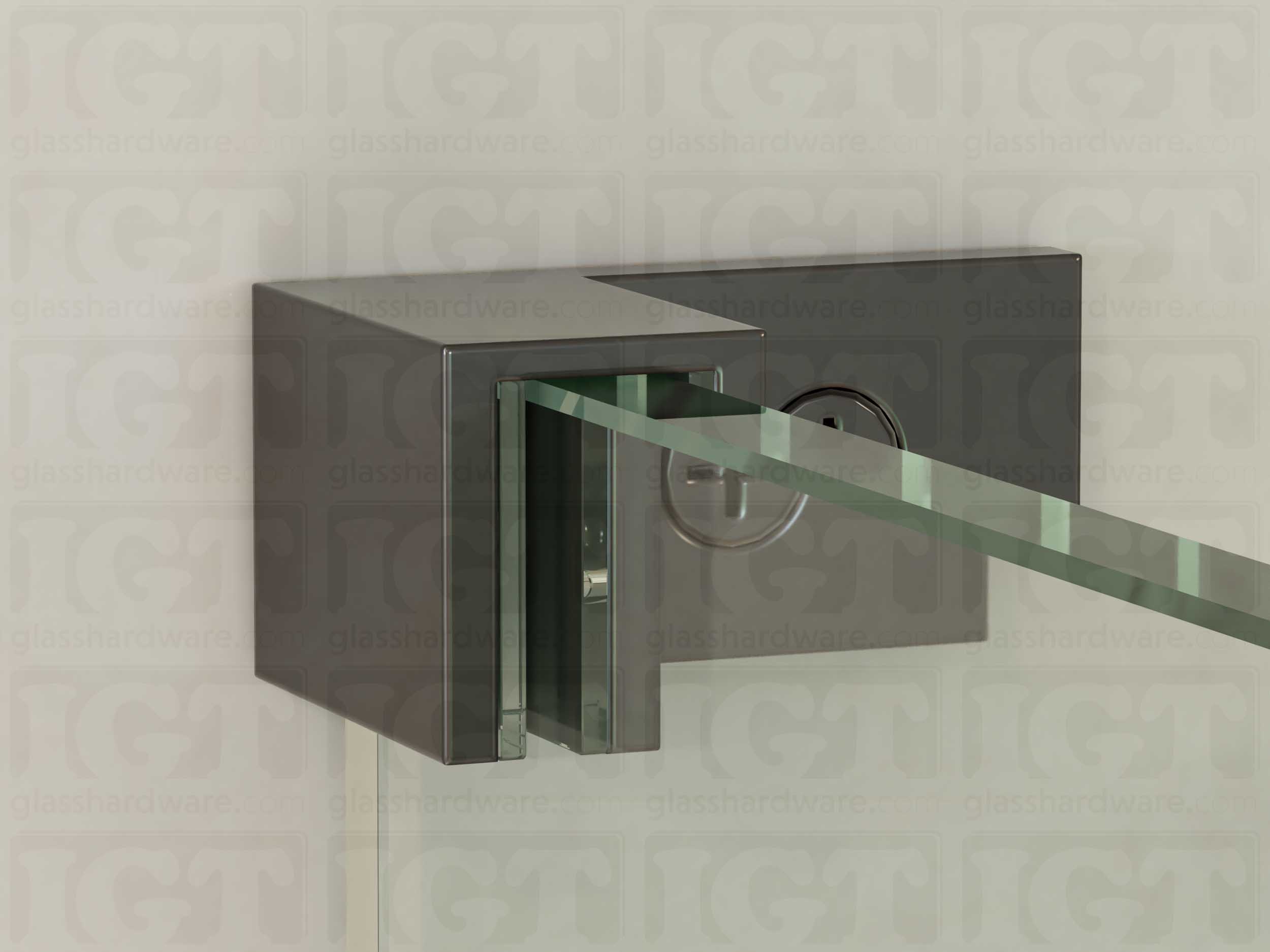 A close up of the Left Wall-to-Glass Sleeve Over Clamp mounted onto the glass panel. The glass is fitted securely into the clamps Solid Brass frame. Polished Gun Metal.