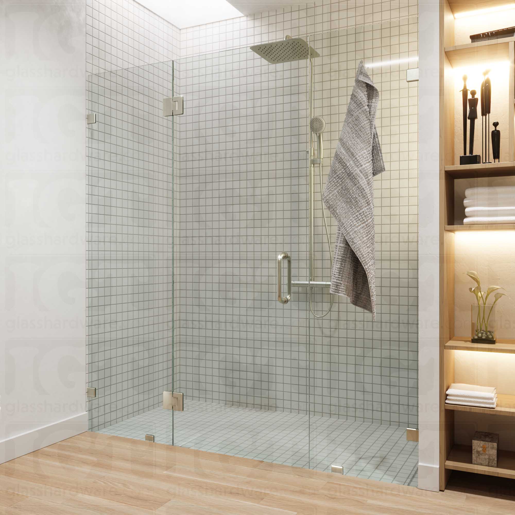 A modern bathroom with a frameless glass shower enclosure, fixed to the wall using Oversized Wall-to-Glass Bilboa Clamps. The shower's white tile walls complement the rest of the bathroom's light wood flooring and furnishings. Brushed Nickel.