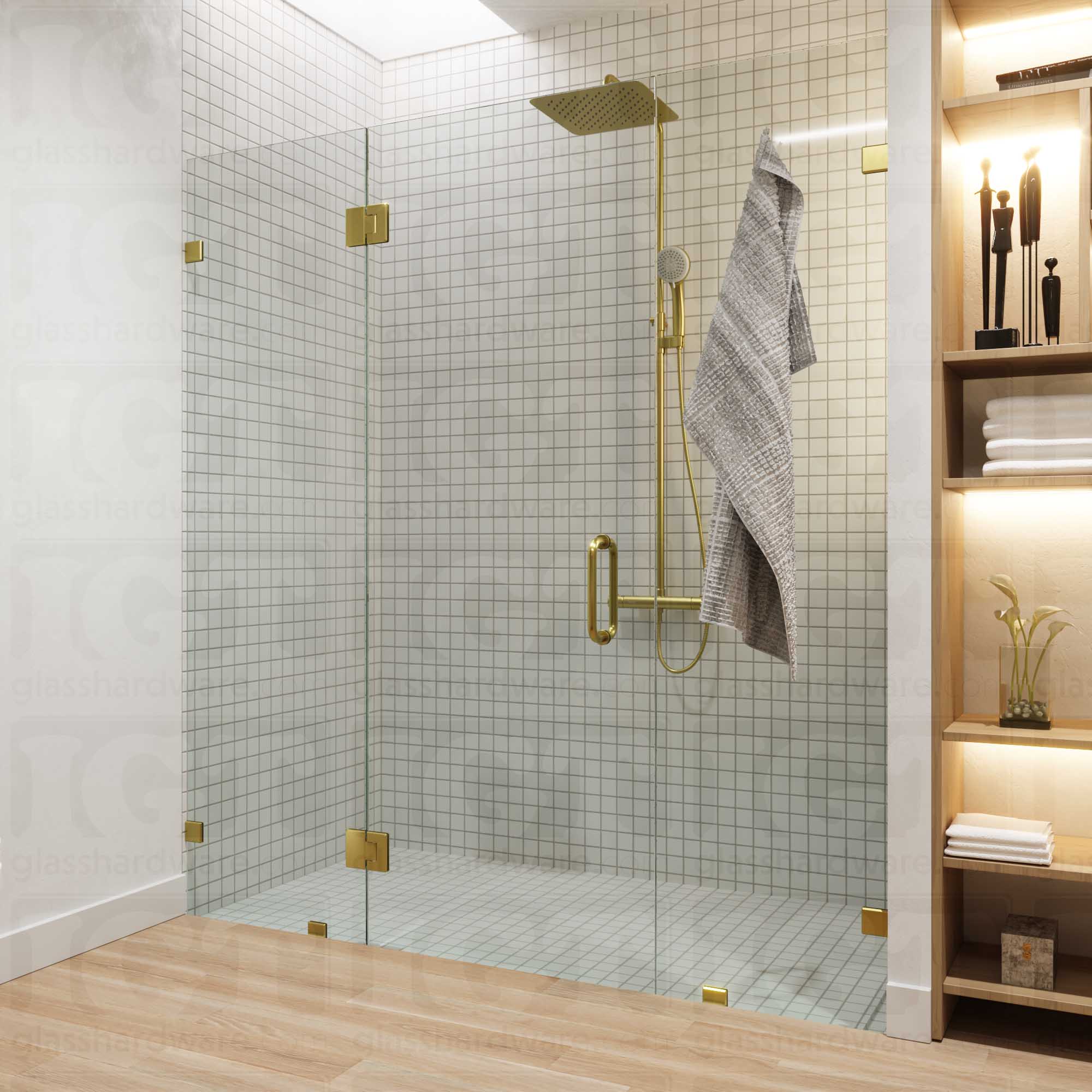 A modern bathroom with a frameless glass shower enclosure, fixed to the wall using Oversized Wall-to-Glass Bilboa Clamps. The shower's white tile walls complement the rest of the bathroom's light wood flooring and furnishings. Gold Brushed.