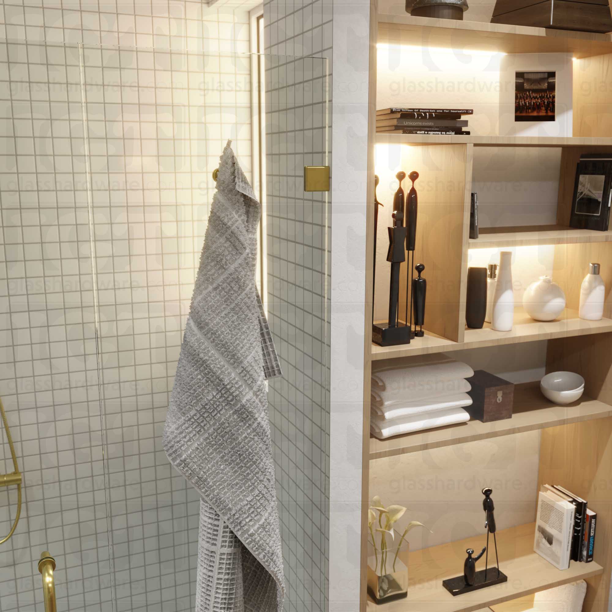 Close-up view of an Oversized Wall-to-Glass Bilboa Clamp mounted to the shower's white tile wall. The hinge's sleek beveled edges complements the bathroom's modern decor. Gold Brushed.