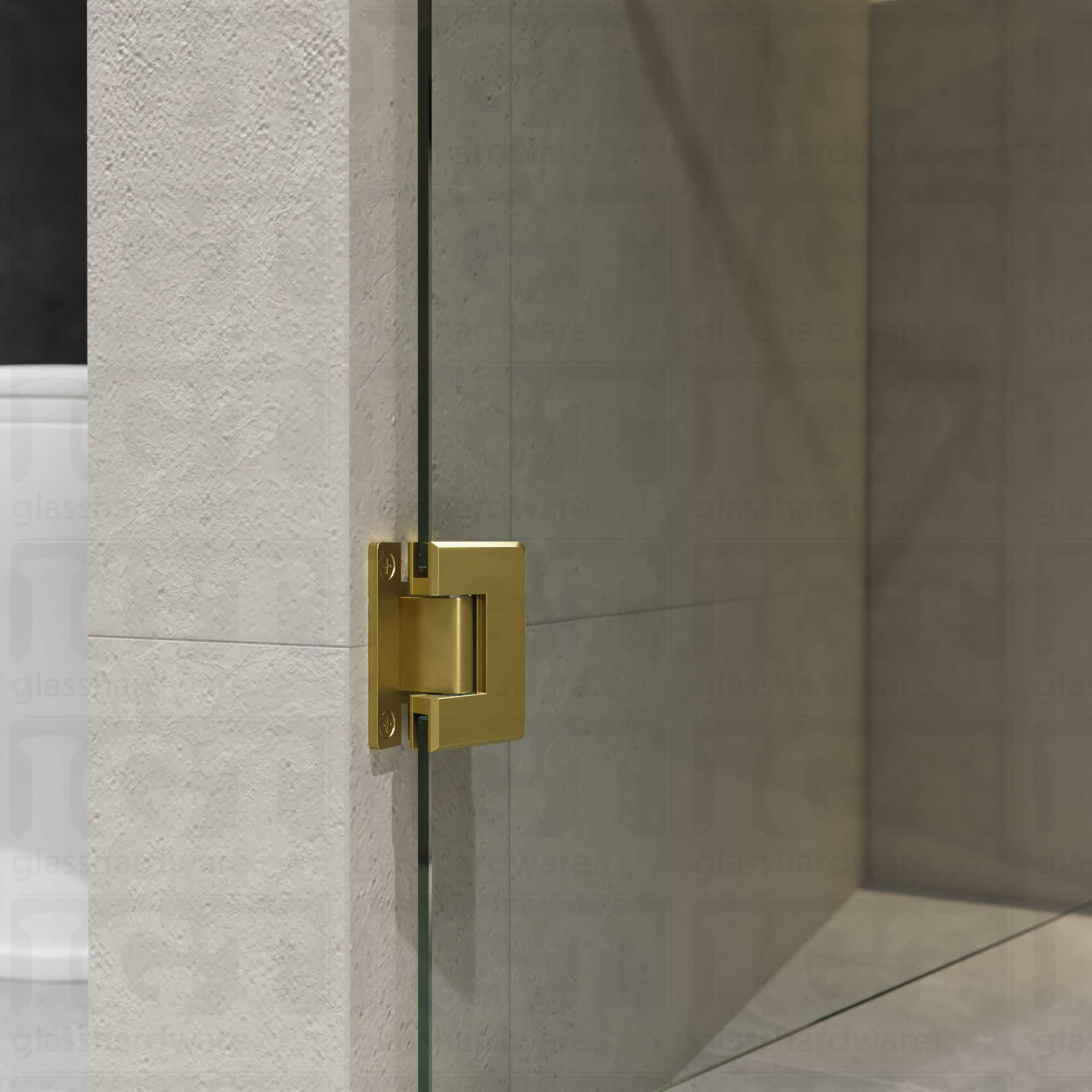 A close-up view of the Wall-to-Glass "H" Back Bilboa Hinge showcasing it's Gold Brushed finish in more detail.