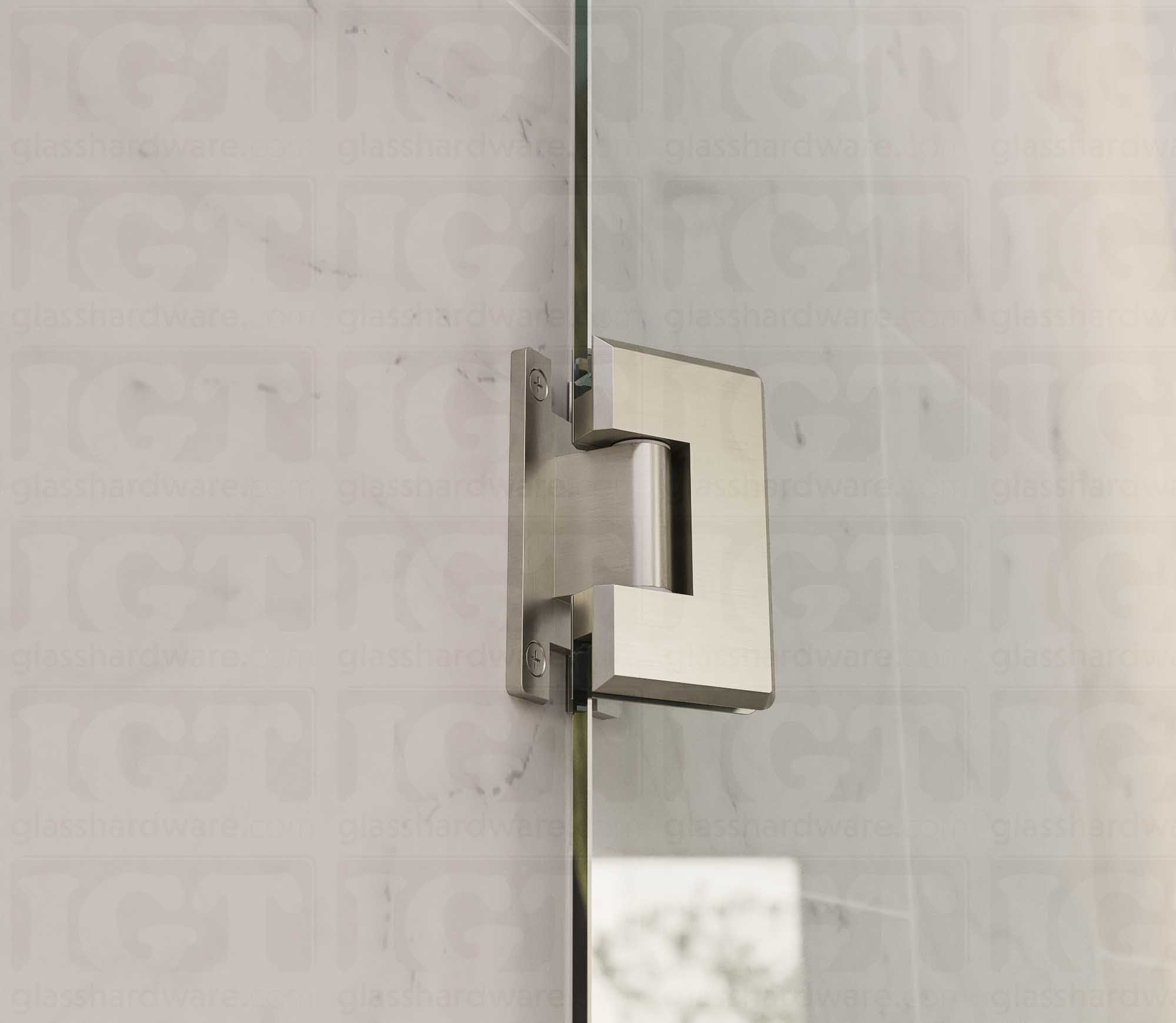 A close up view of the Heavy Duty Wall-to-Glass “H” Back Bilboa Hinge installed on a frameless glass shower door. Brushed Nickel.