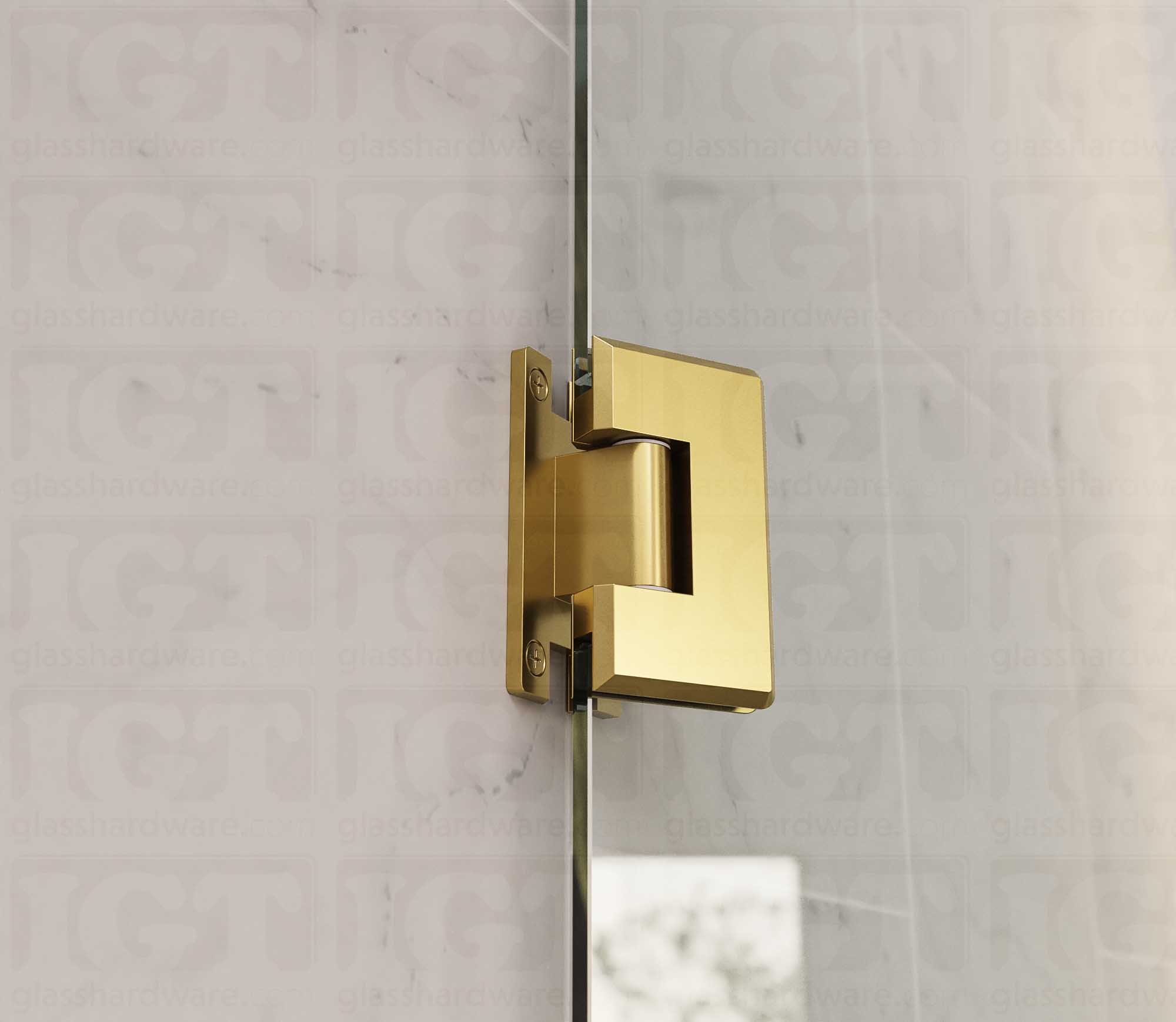 A close up view of the Heavy Duty Wall-to-Glass “H” Back Bilboa Hinge installed on a frameless glass shower door. Gold Brushed.