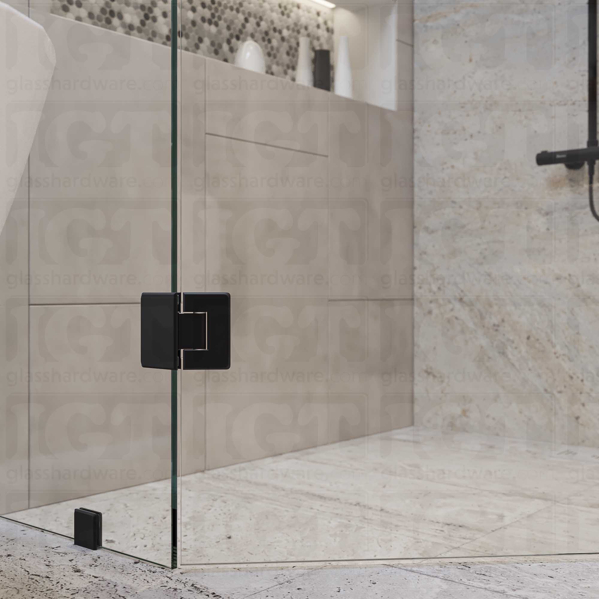 A close-up view of the top Glass-to-Glass 135 Degree Bilboa Hinge installed on a modern shower door, showcasing how the hinge securely holds the adjacent glass panels. Matte Black.