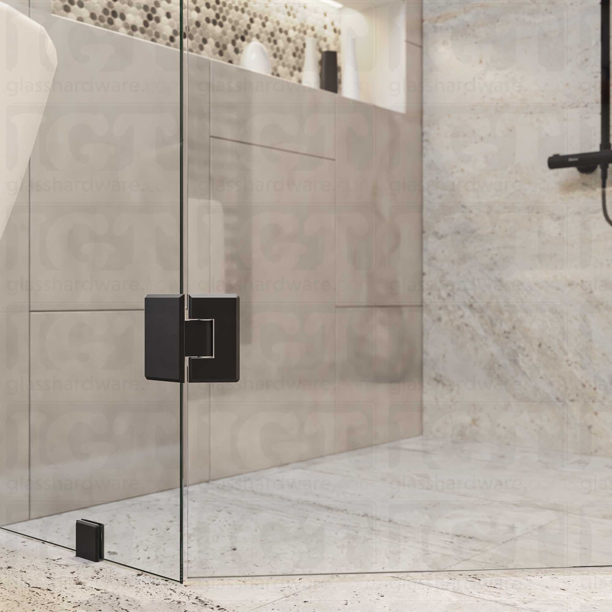 A close-up view of the bottom Heavy Duty Glass-to-Glass 135 Degree Bilboa Hinge installed on a neo angle shower door. Matte Black.