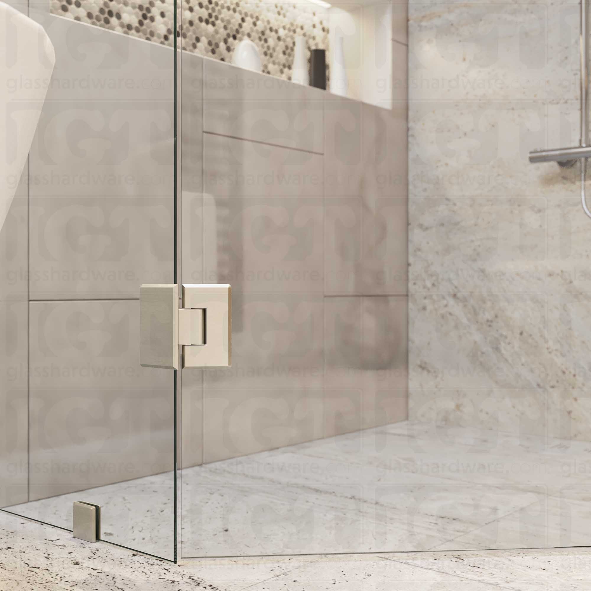 A close-up view of the bottom Heavy Duty Adjustable Glass-to-Glass 135 Degree Bilboa Hinge installed on a neo angle shower door. Brushed Nickel.