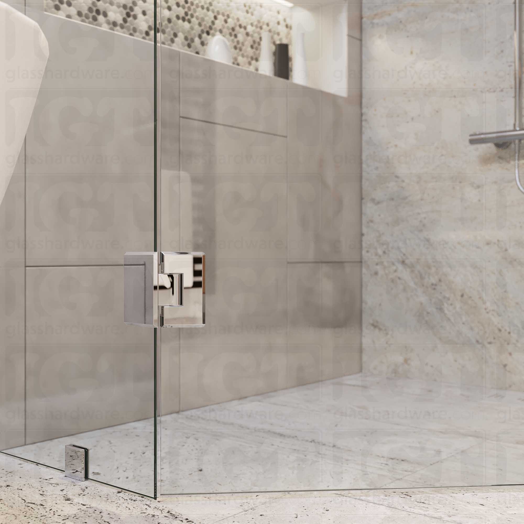 A close-up view of the bottom Heavy Duty Adjustable Glass-to-Glass 135 Degree Bilboa Hinge installed on a neo angle shower door. Chrome Polished.