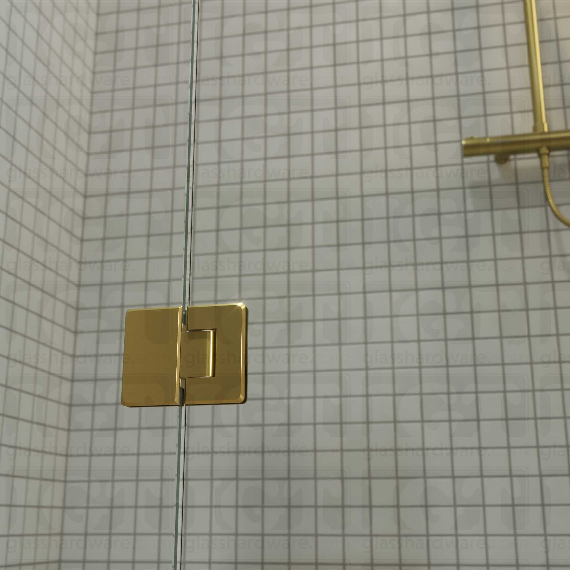 A close-up view of the bottom Glass-to-Glass 180 Degree Bilboa Hinge installed on a modern shower door. Gold Brushed.