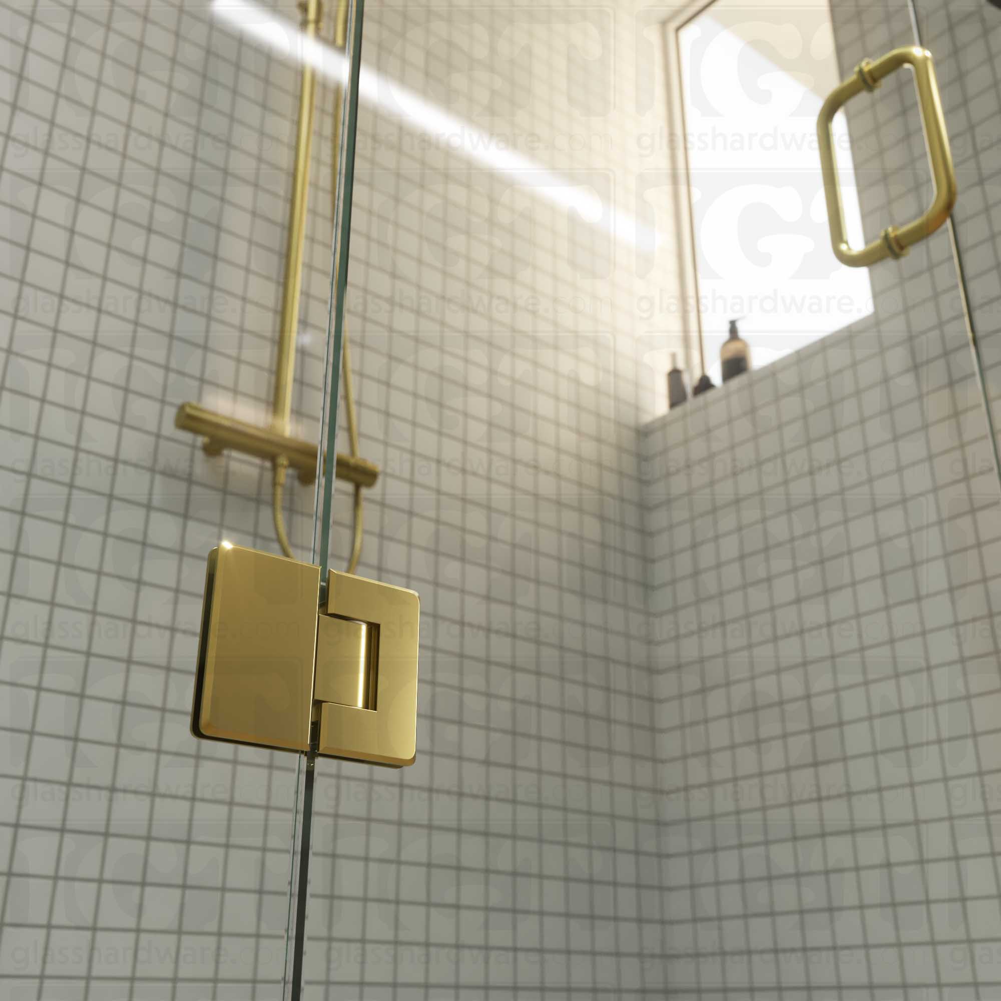 A close-up view of the bottom Glass-to-Glass 180 Degree Bilboa Hinge installed on a modern shower door in the closed position, showcasing its beveled-edge design in more detail. Gold Brushed.