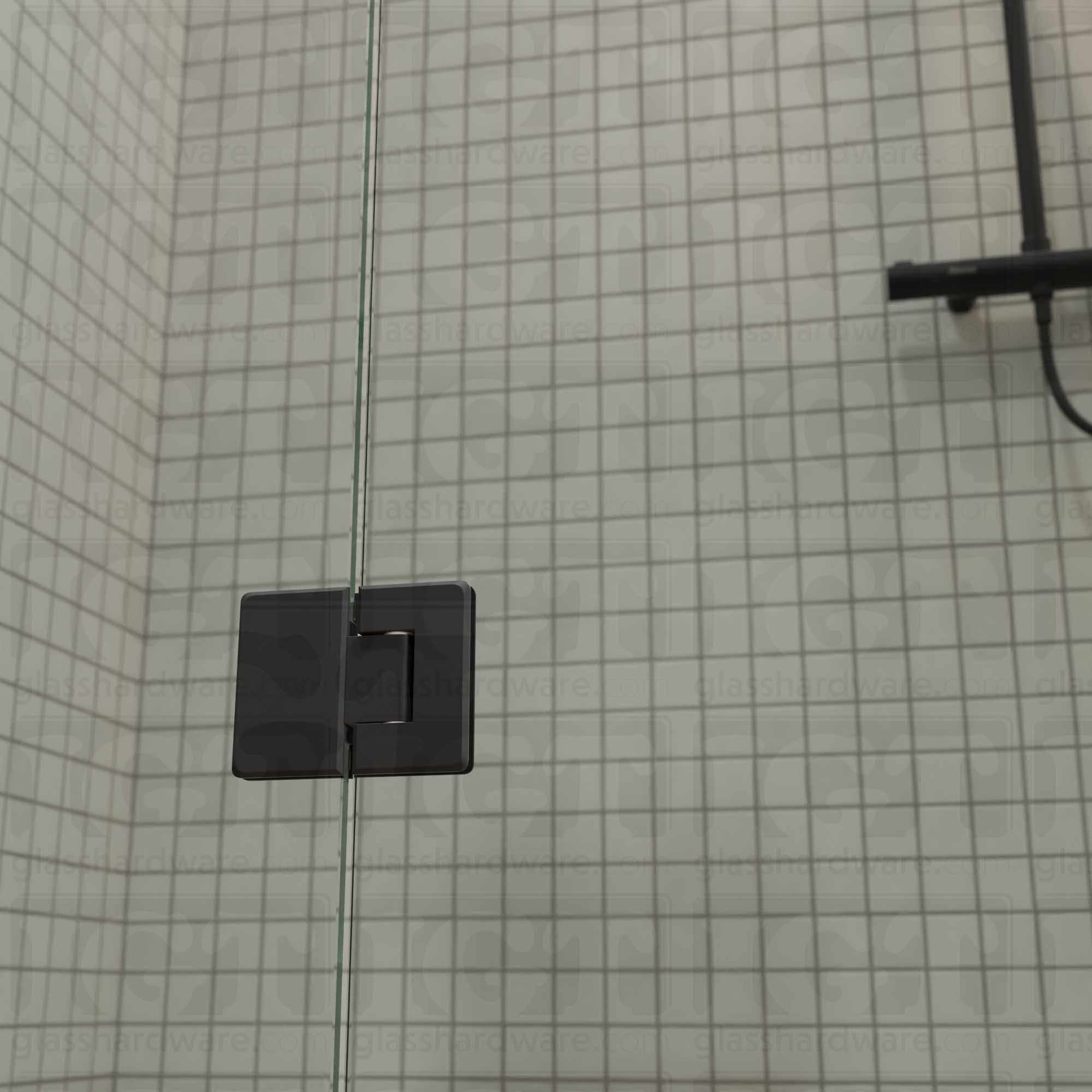 A close-up view of the bottom Glass-to-Glass 180 Degree Bilboa Hinge installed on a modern shower door. Matte Back.