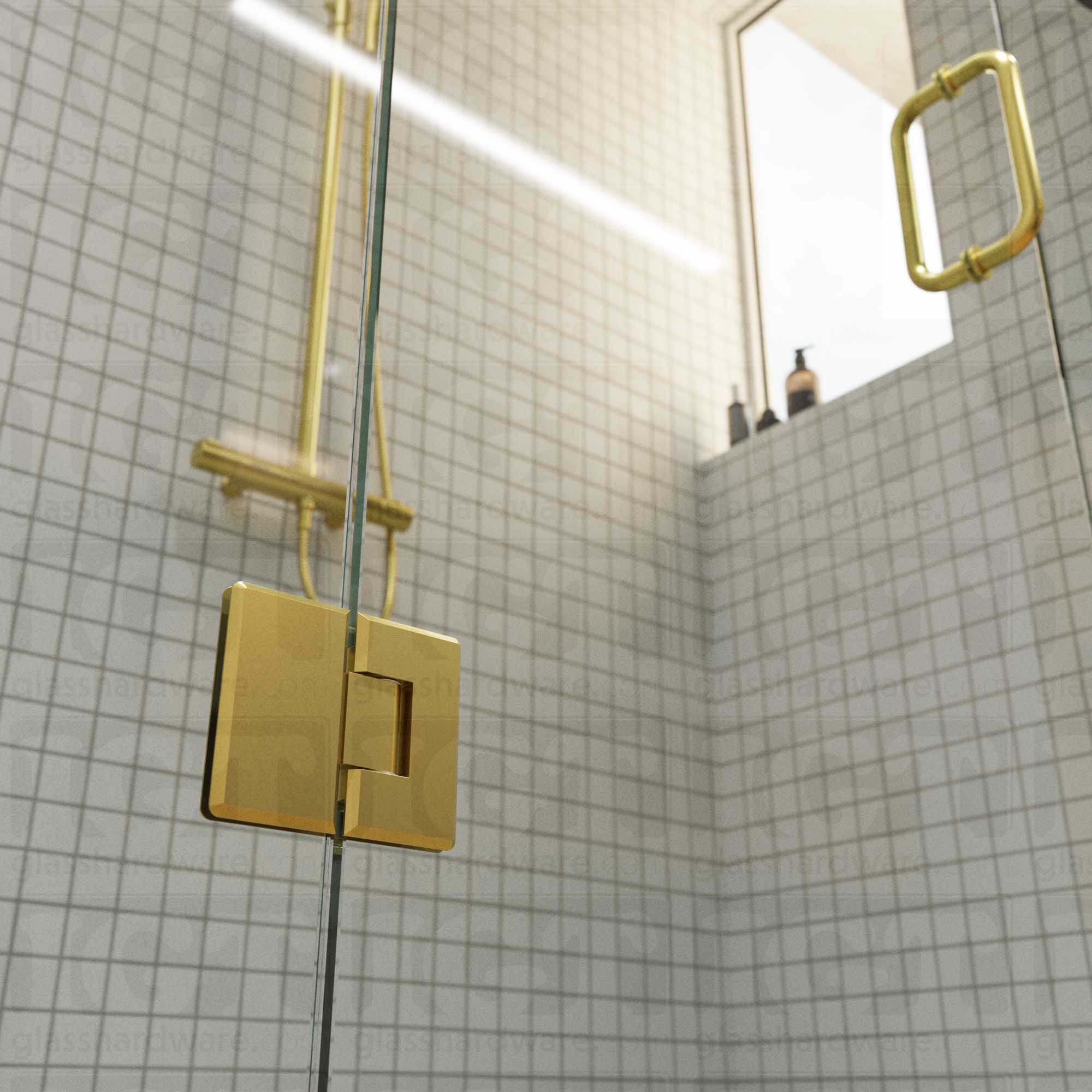 A close-up view of the bottom Heavy Duty Glass-to-Glass 180 Degree Bilboa Hinge installed on a modern shower door in the closed position, showcasing its beveled-edge design in more detail. Gold Brushed.