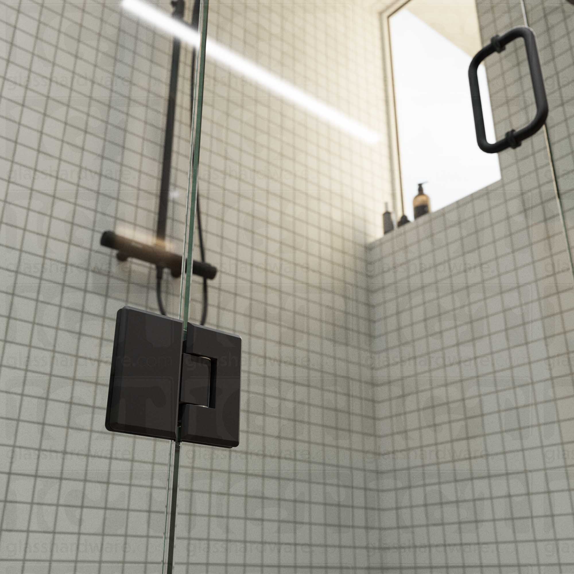 A close-up view of the bottom Heavy Duty Glass-to-Glass 180 Degree Bilboa Hinge installed on a modern shower door in the closed position, showcasing its beveled-edge design in more detail. Matte Black.