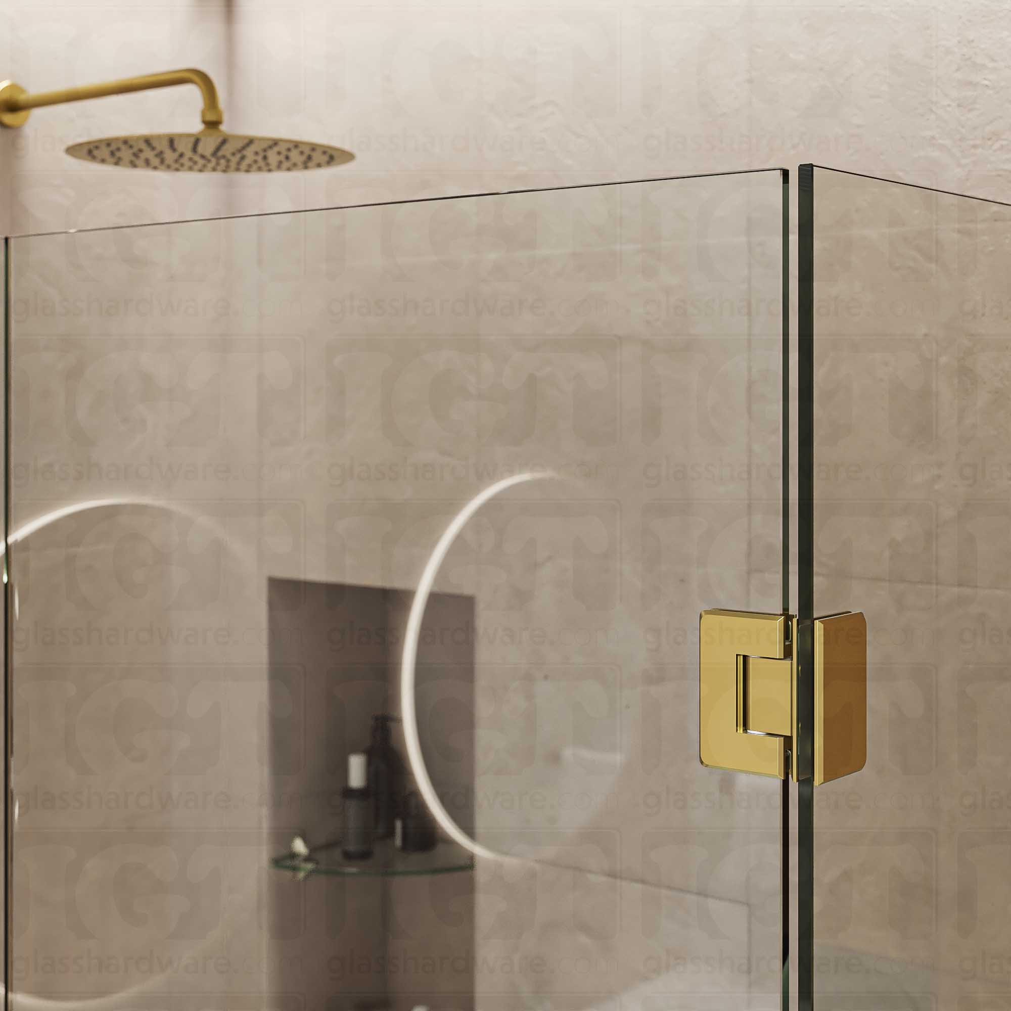 A close-up view of the top Glass-to-Glass 90 Degree Bilboa Hinge installed on a modern shower door, showcasing how the hinge securely holds the adjacent glass panels. Gold Brushed.