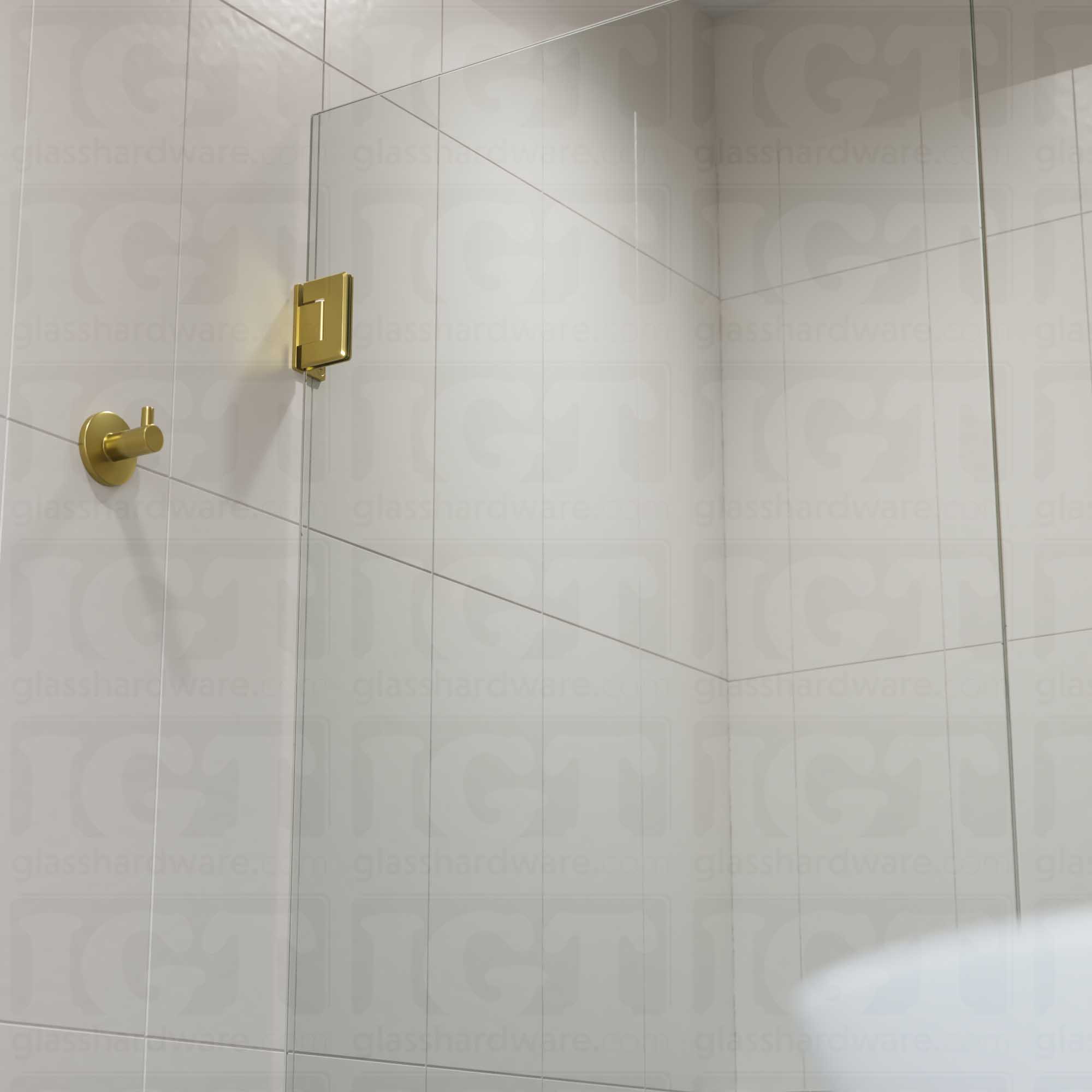 A close-up view of the top Wall-to-Glass Offset Back Bilboa Hinge installed on a modern shower door. Gold Brushed.