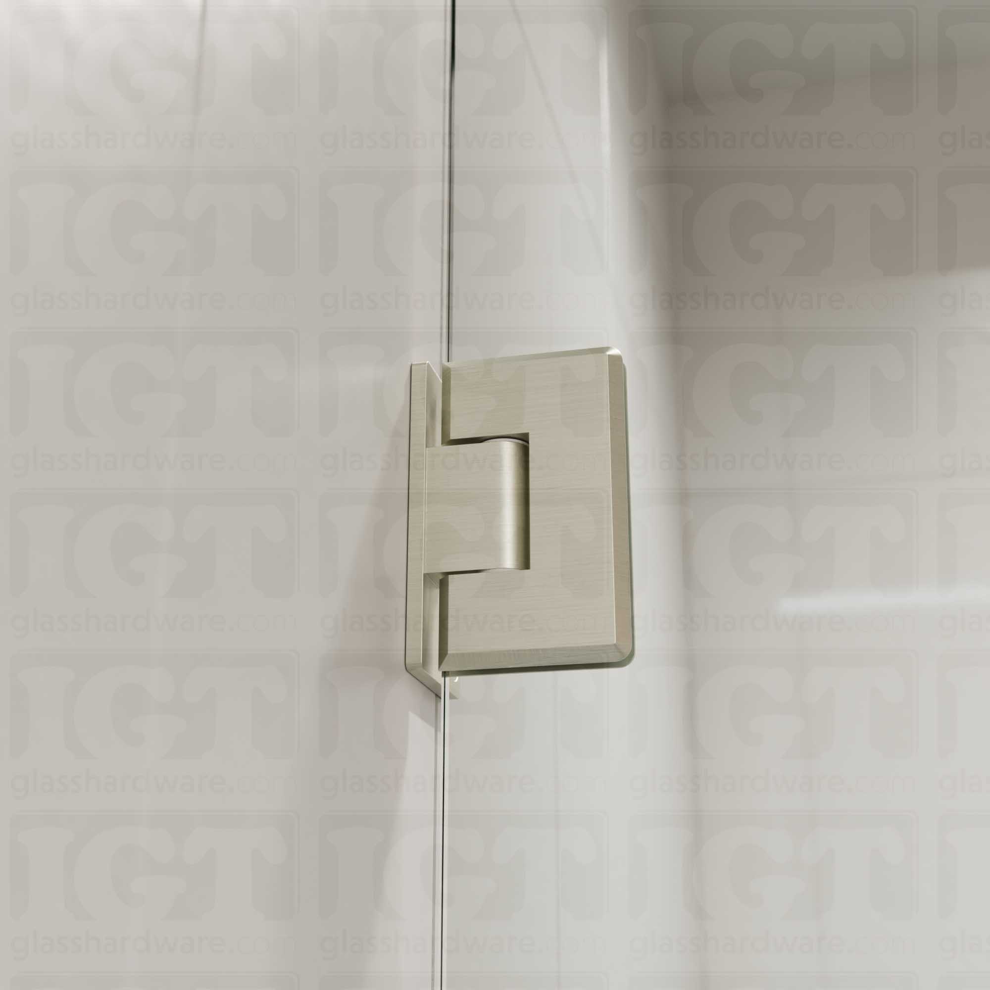 A close-up view of the Heavy Duty Wall-to-Glass Offset Back Bilboa Hinge installed on a modern shower door, showcasing it's rounded corners and beveled edges. Brushed Nickel.