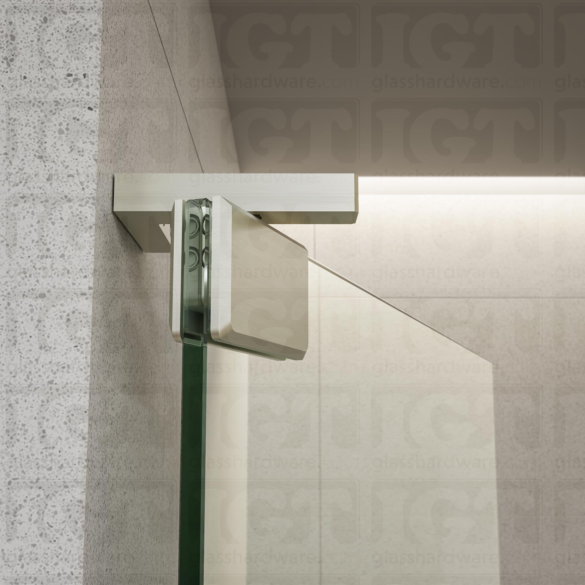 Close-up of the Right Wall Mount Bilboa Pivot Hinge mounted at the top of the glass shower door, in the open position. The hinge has soft rounded corners and sleek beveled edges, adding a touch elegance to the shower enclosure. Brushed Nickel.