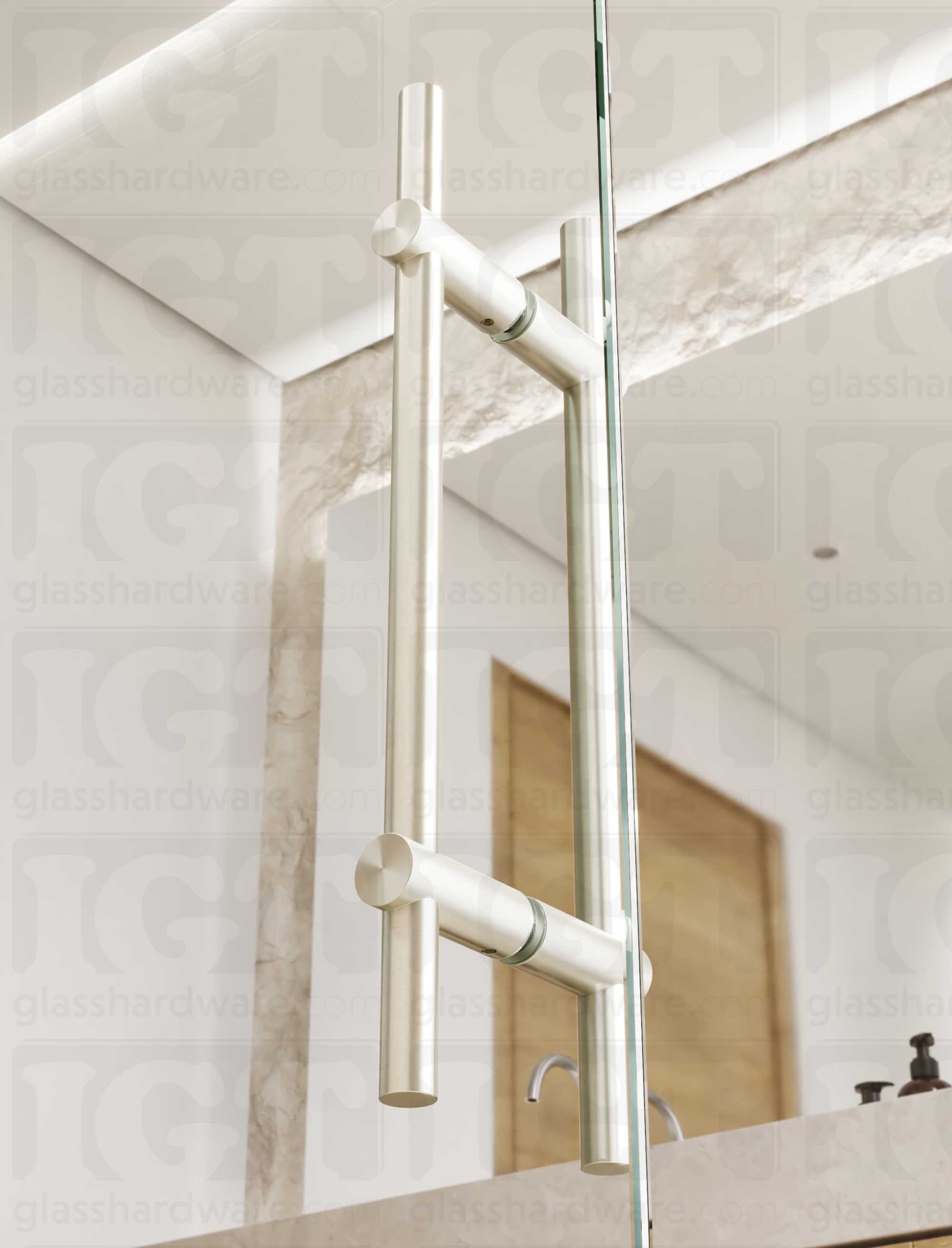 Close up view of the 16" Round Adjustable Ladder Handle installed on a glass shower door. Natural light coming through the bathroom window lands softly on the handle's Brushed Nickel finish.