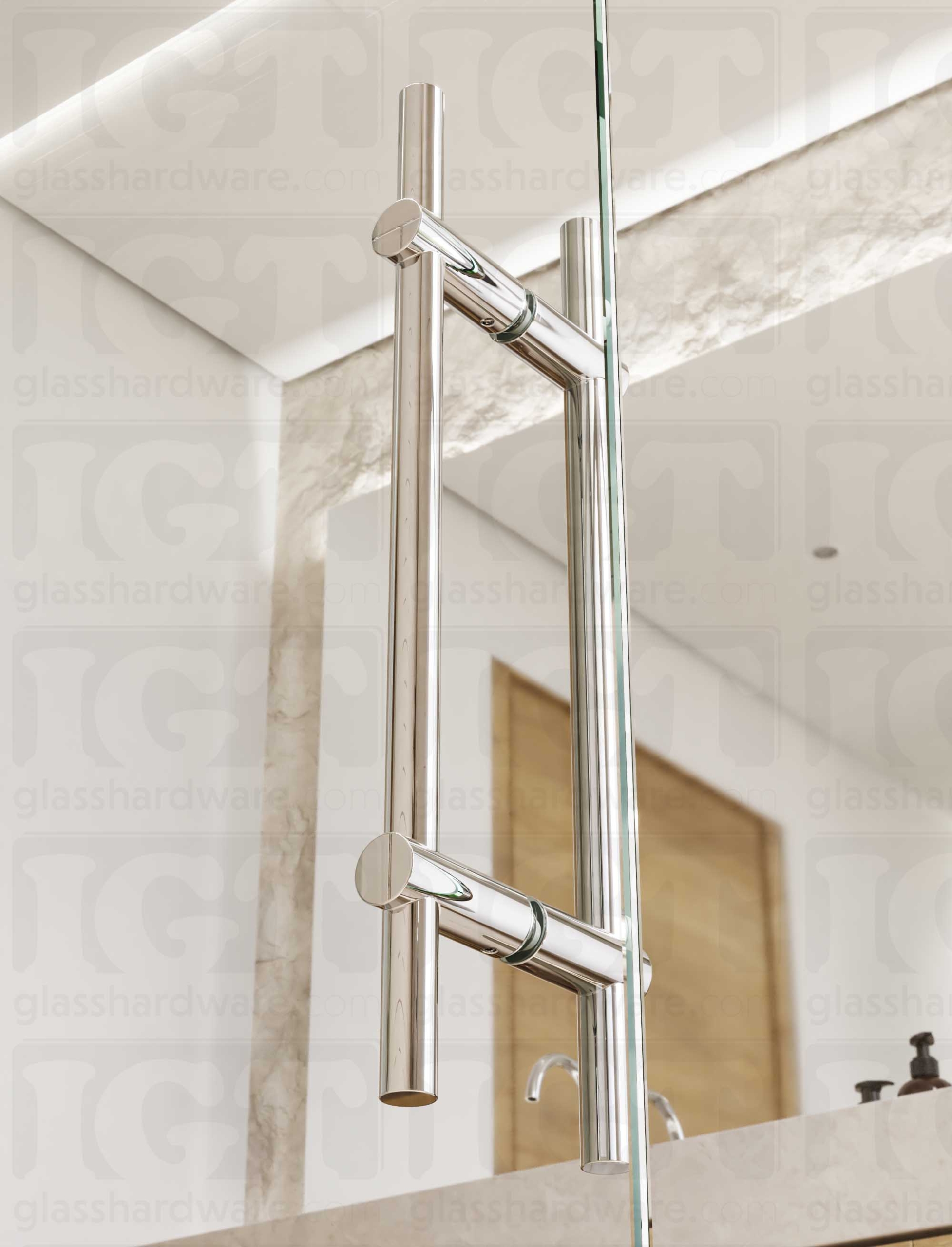 Close up view of the 16" Round Adjustable Ladder Handle installed on a glass shower door. Natural light coming through the bathroom window lands softly on the handle's Chrome Polished finish.