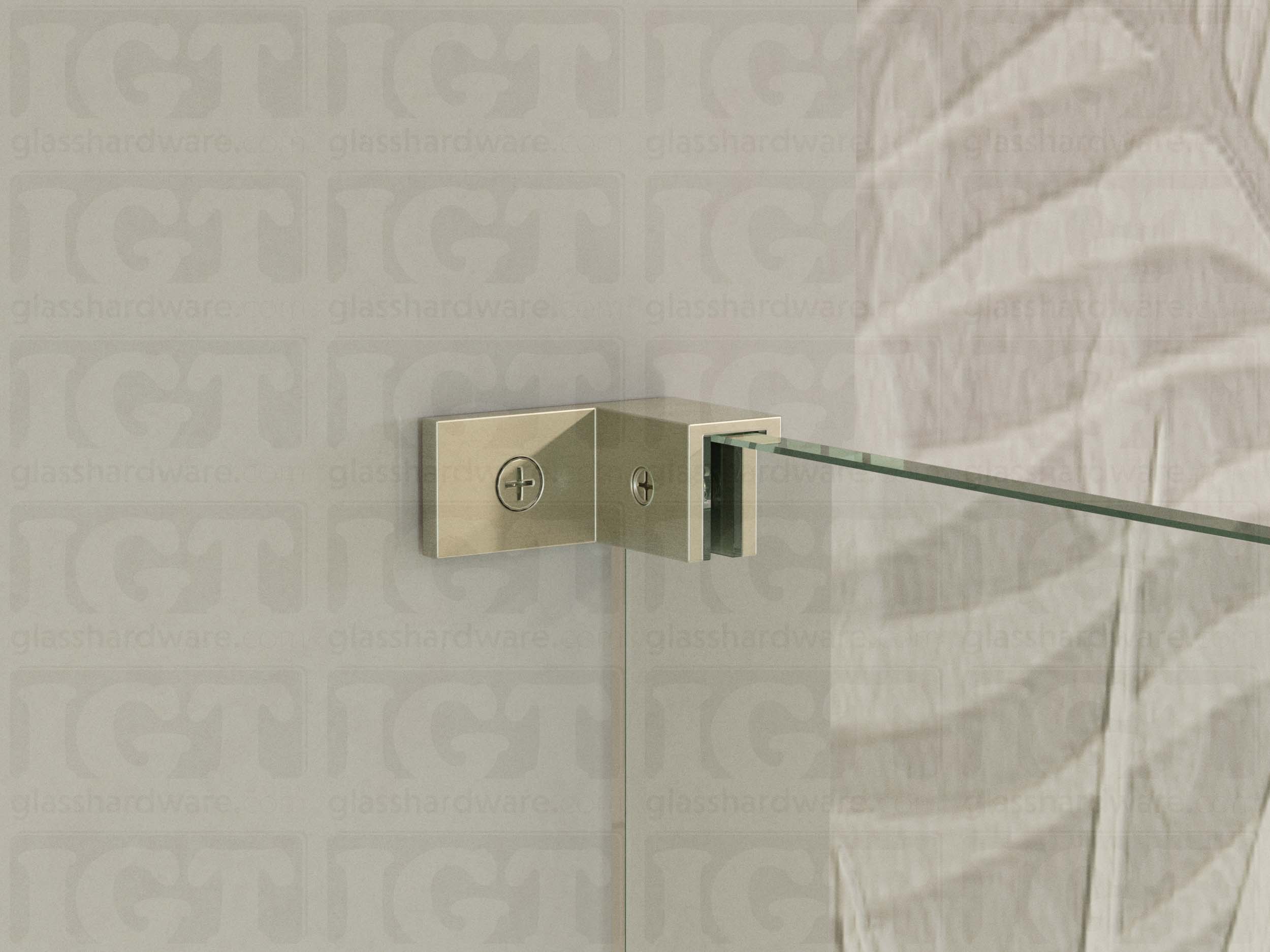 A close up of the Right Wall-to-Glass Sleeve Over Clamp installed on a frameless glass shower enclosure. The clamp is securely mounted to the shower's wall, providing additional support to the overall installation. Brushed Nickel.