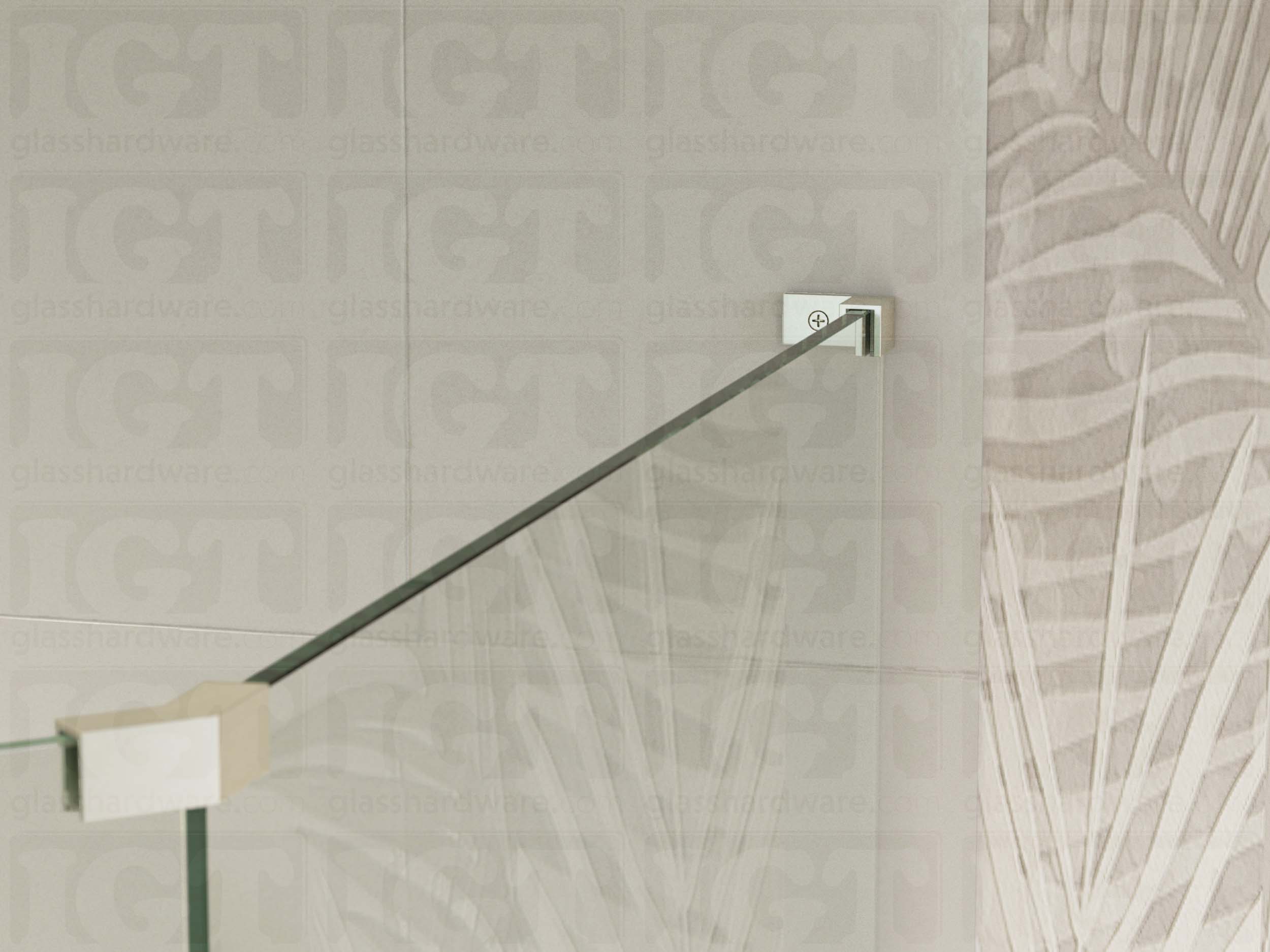 A view of the glass shower enclosure's upper section. The fixed panel is secured to the wall with a Right Wall-to-Glass Sleeve Over Clamp, and joined to an adjacent panel with a glass-to-glass clamp. Brushed Nickel.