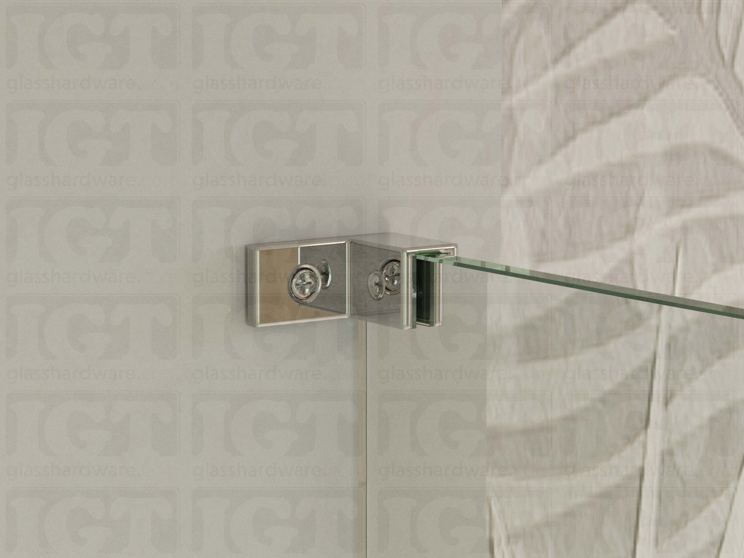 A close up of the Right Wall-to-Glass Sleeve Over Clamp installed on a frameless glass shower enclosure. The clamp is securely mounted to the shower's wall, providing additional support to the overall installation. Chrome Polished.