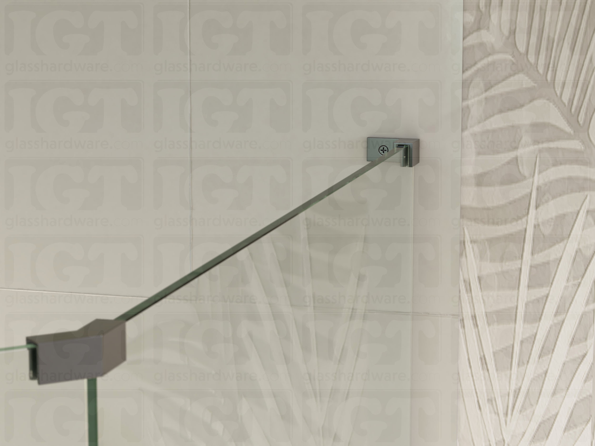 A view of the glass shower enclosure's upper section. The fixed panel is secured to the wall with a Right Wall-to-Glass Sleeve Over Clamp, and joined to an adjacent panel with a glass-to-glass clamp. Polished Gun Metal.