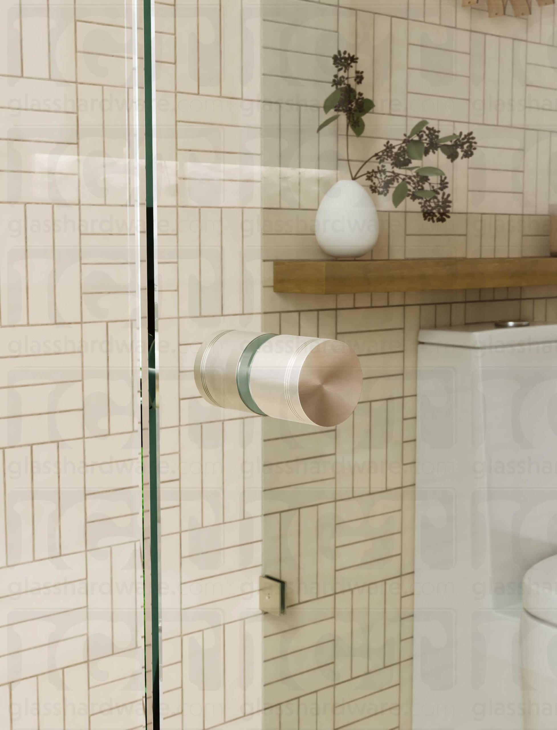 A close up of the Contemporary Style Door Knob installed on a glass shower door. The door knob's back-to-back design is tightly secured to the glass door. Brushed Nickel.