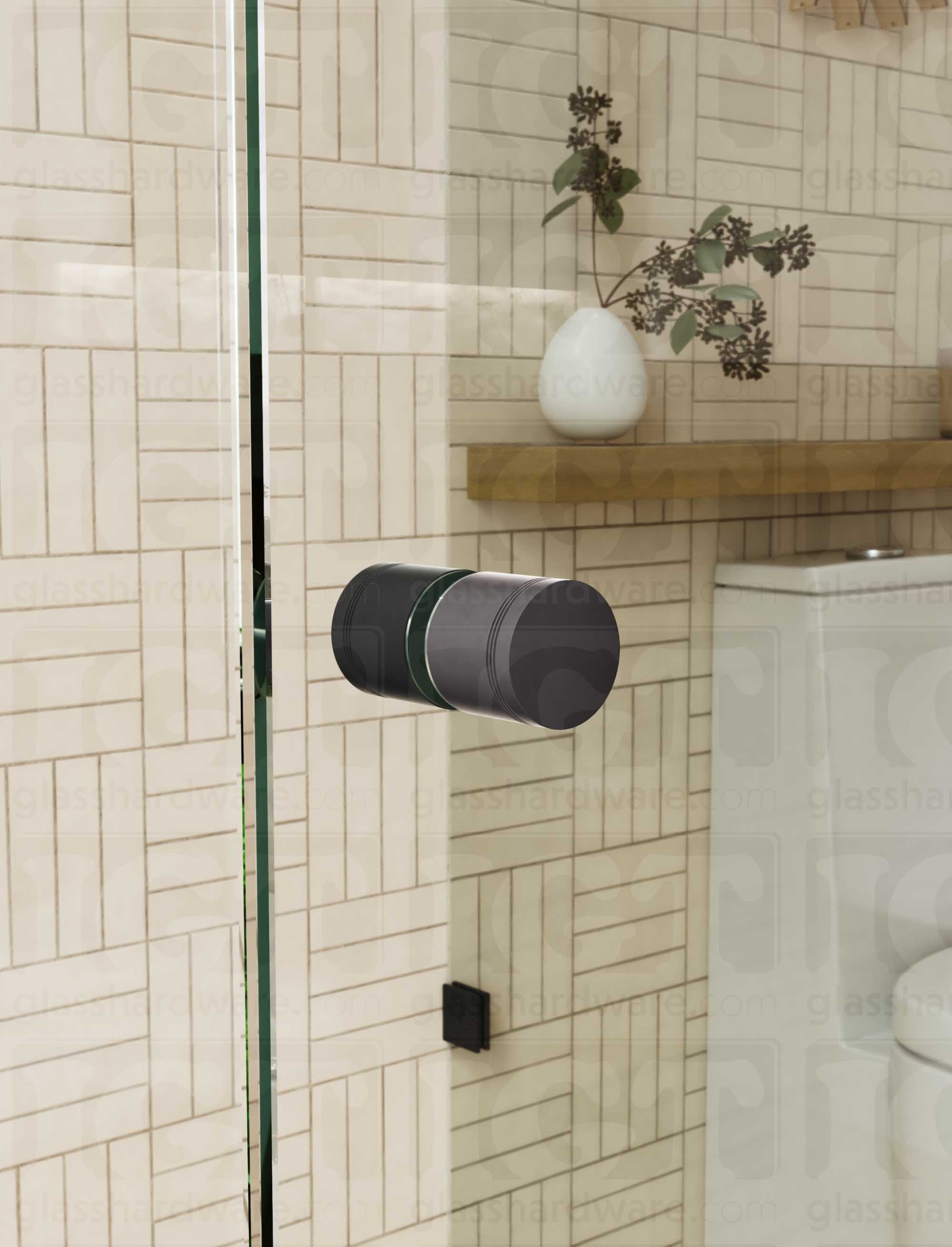 A close up of the Contemporary Style Door Knob installed on a glass shower door. The door knob's back-to-back design is tightly secured to the glass door. Matte Black.