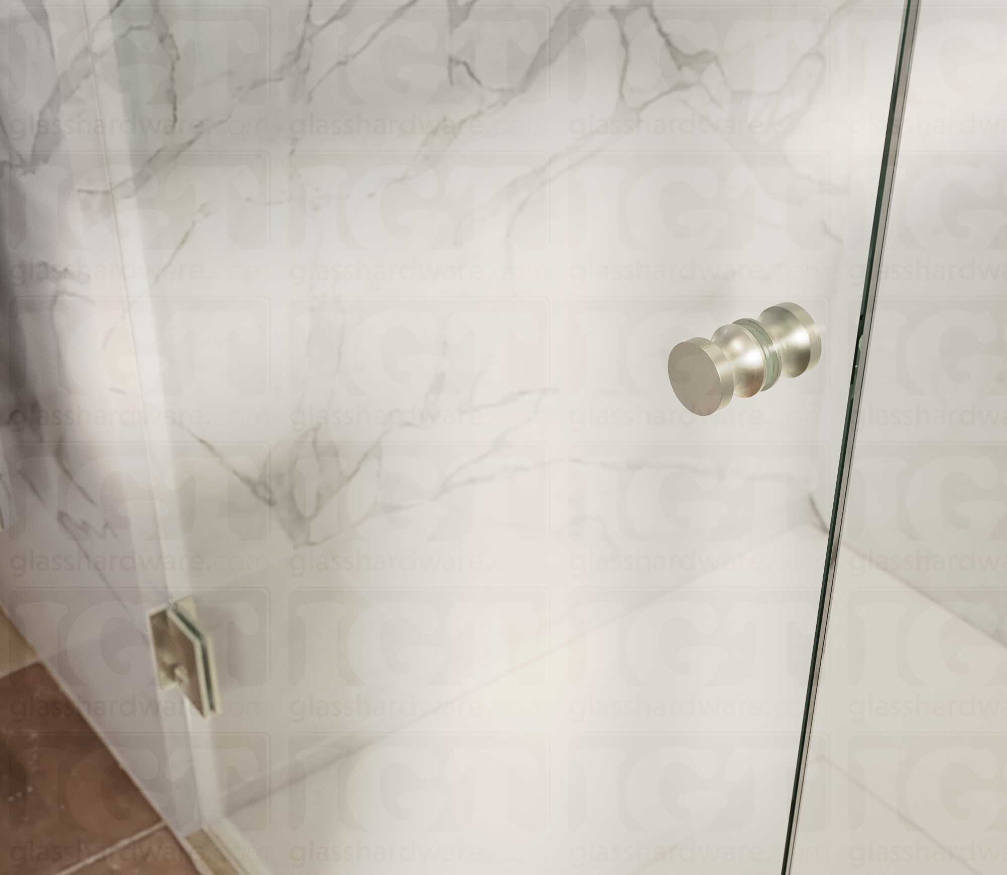 A close up of the European Style Back-to-Back Door Knob installed on a glass shower door. Brushed Nickel.