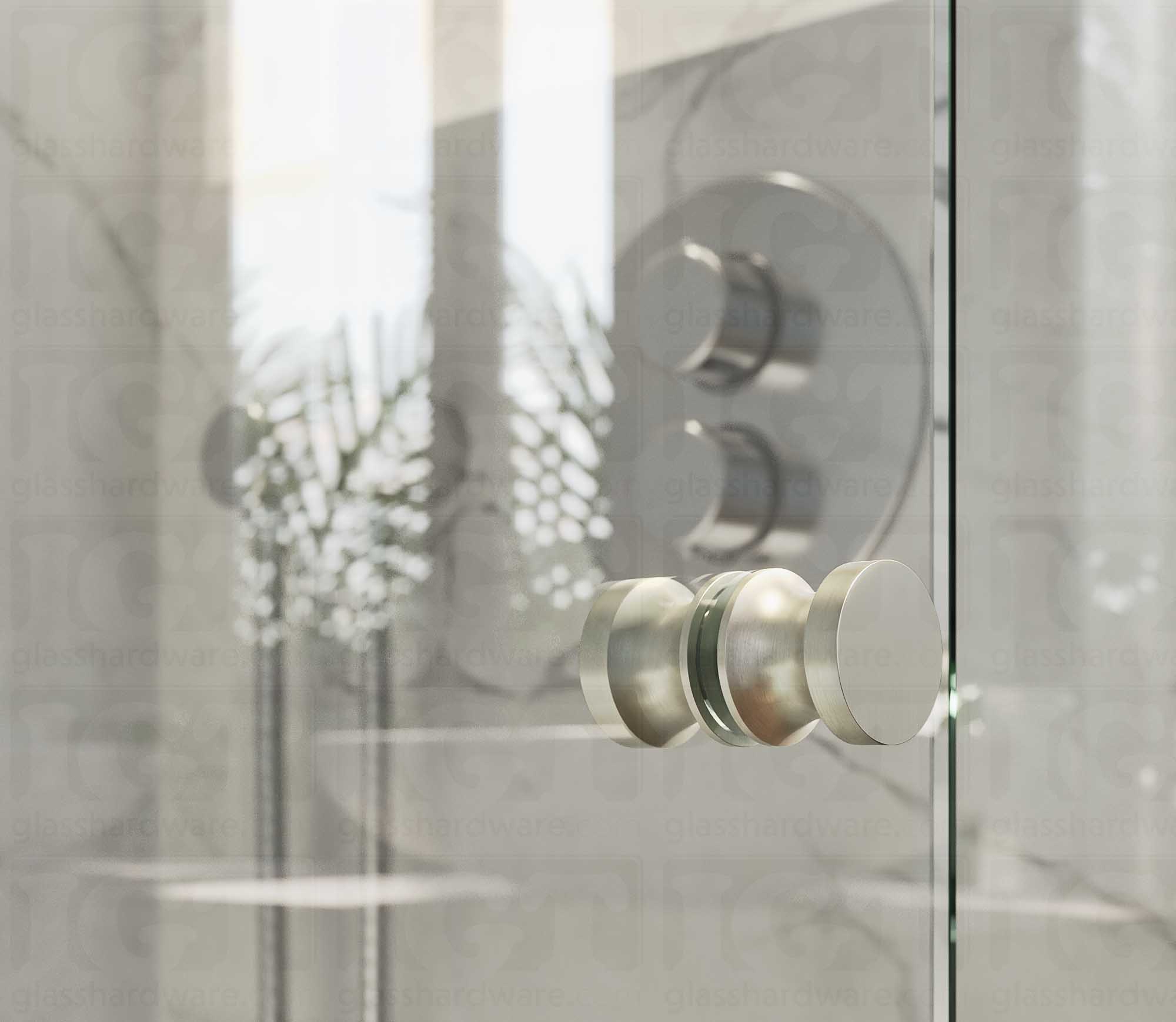 A close up of the European Style Back-to-Back Door Knob installed on a glass shower door. The door knob's back-to-back design is tightly secured to the glass door. Brushed Nickel.