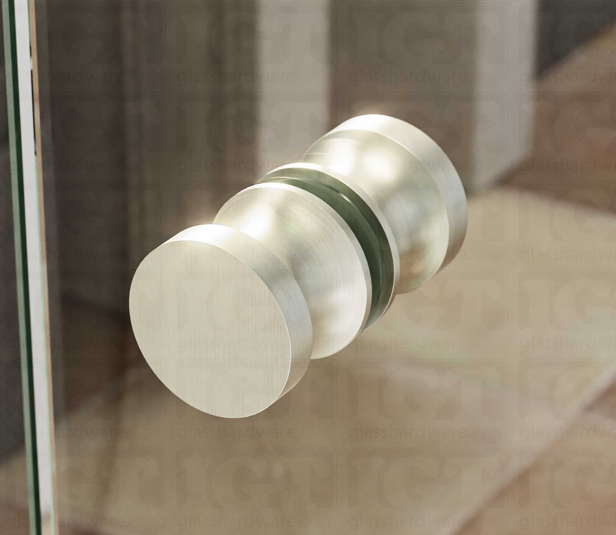 A close up of the European Style Back-to-Back Door Knob installed on a glass shower door. Soft natural light highlights the knob's Brushed Nickel finish.